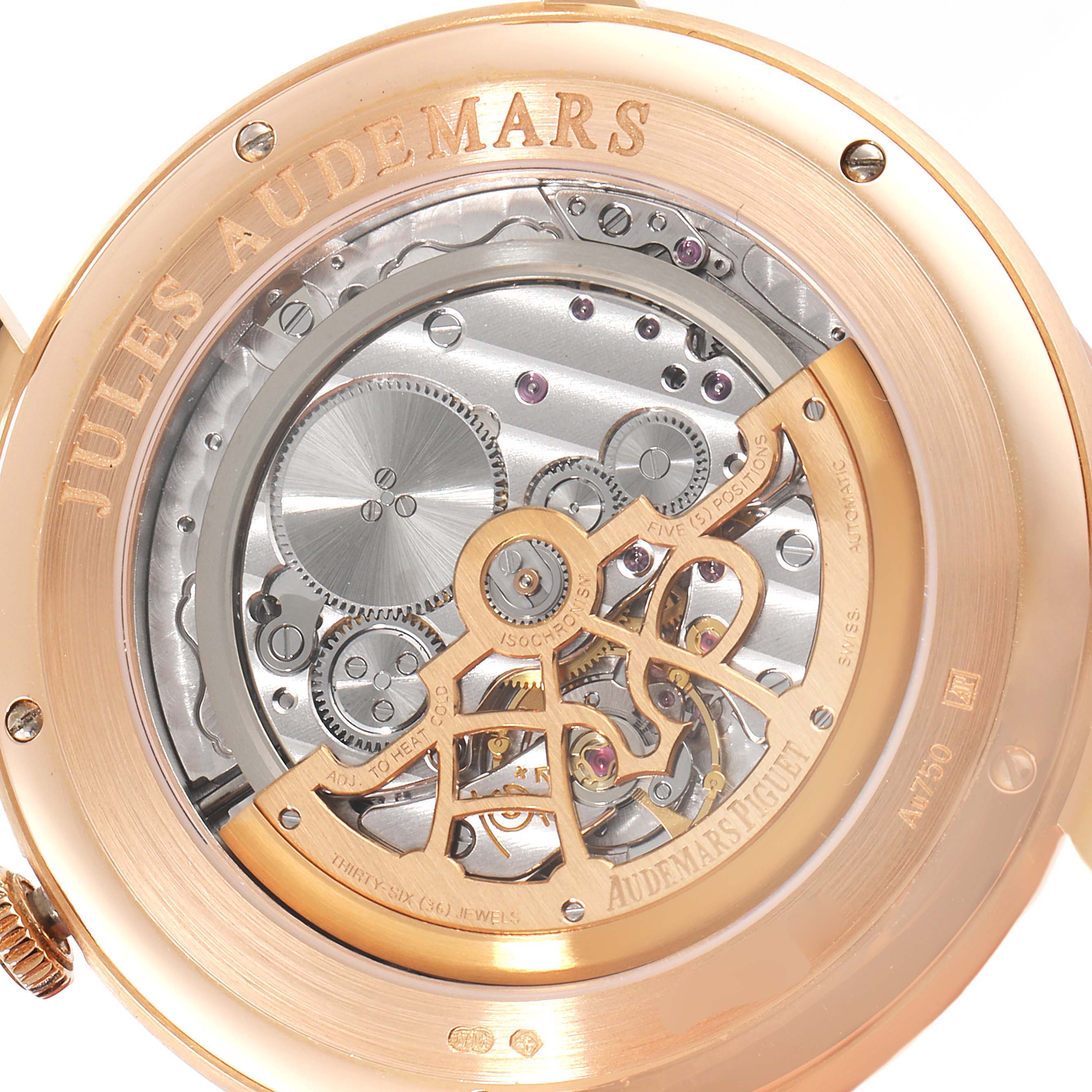 The image shows the back view of the Audemars Piguet Jules 15180OR.OO.A102CR.01 Men's Rose Gold Silver Dial 15180OR.OO.A102CR.01 Men's Rose Gold Silver Dial model, highlighting its intricate mechanical movement.