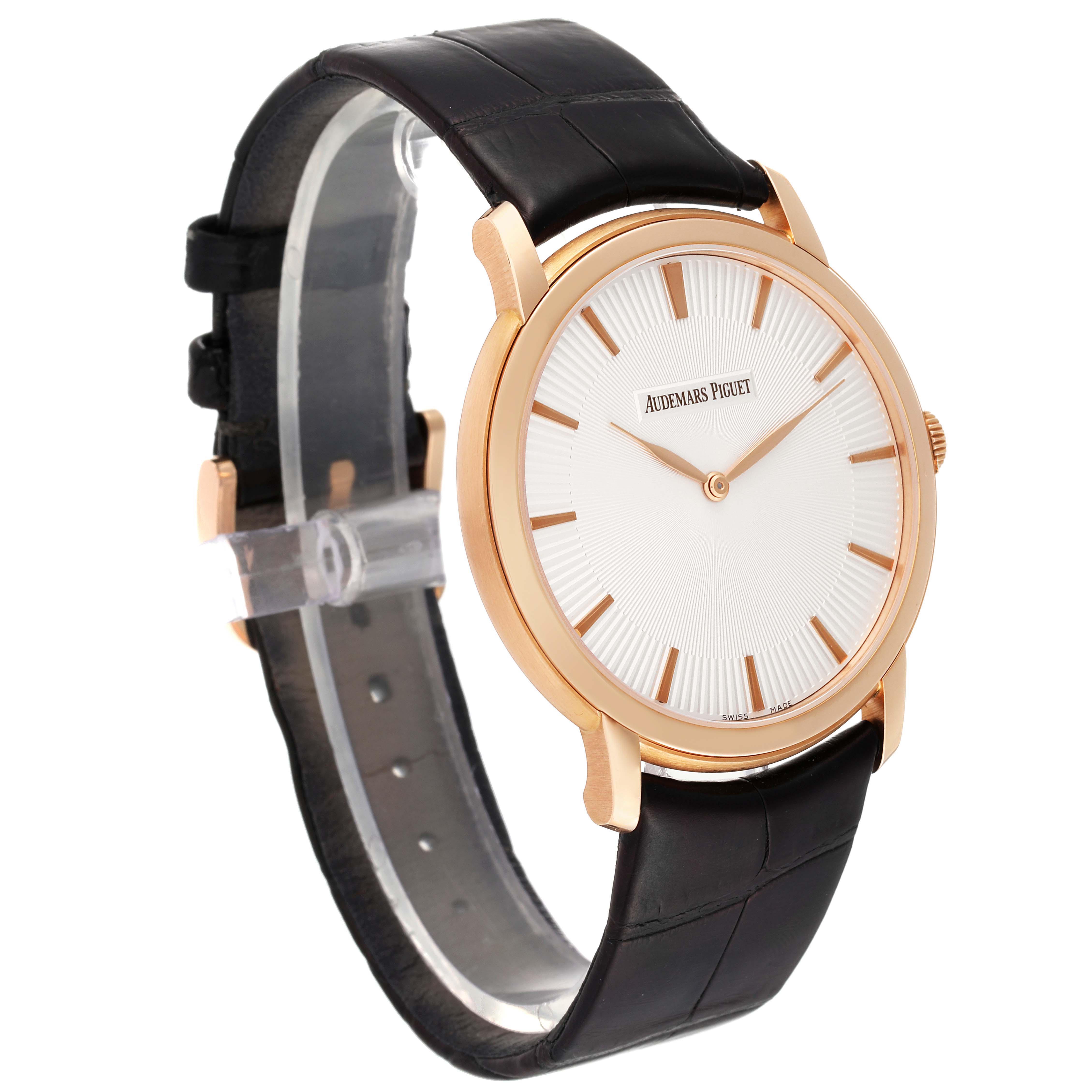 The image shows a Jules model by Audemars Piguet at a three-quarter angle, highlighting its face, leather strap, and gold-tone case.