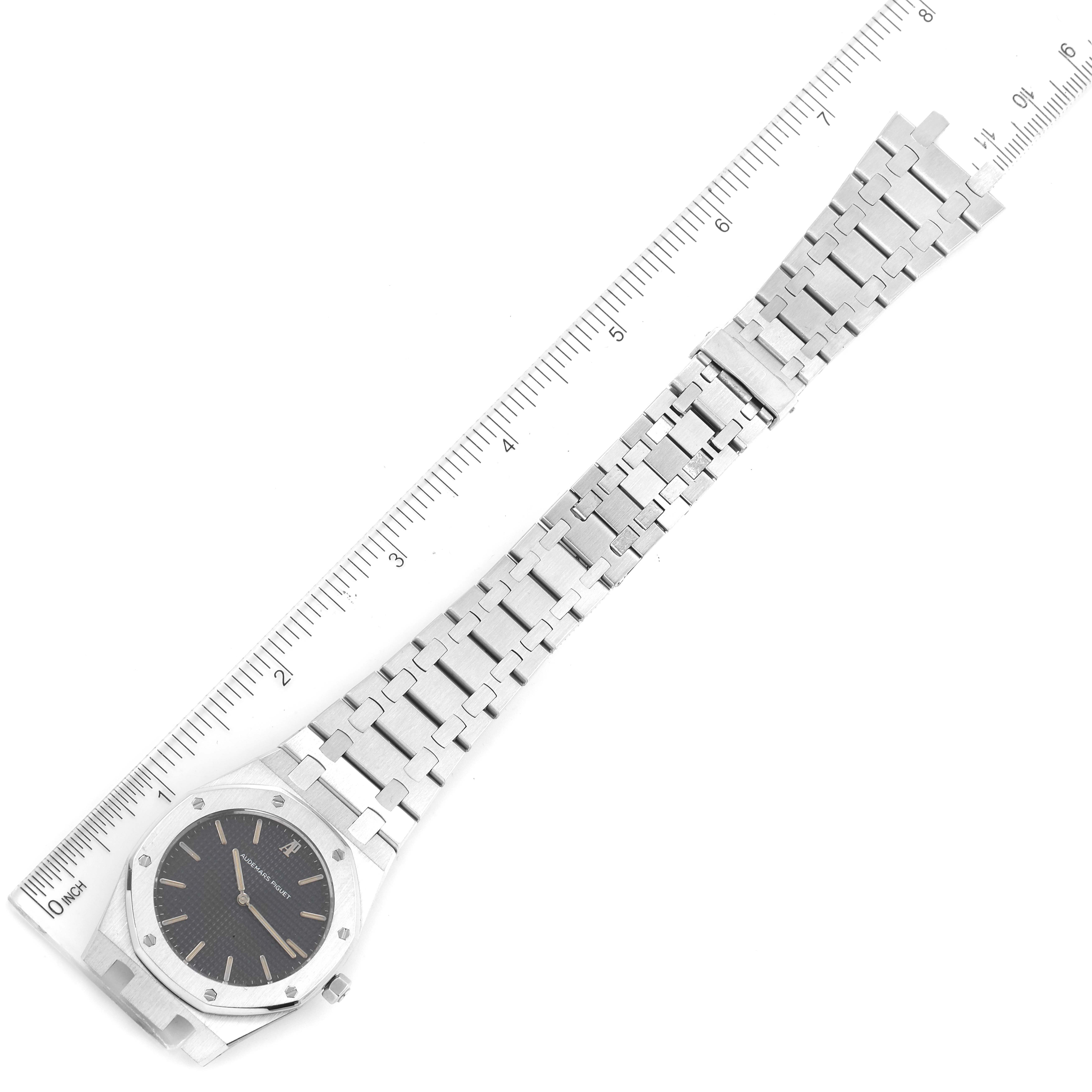 This image shows a top-down view of the Royal Oak watch by Audemars Piguet along with its metal bracelet and rulers for scale.