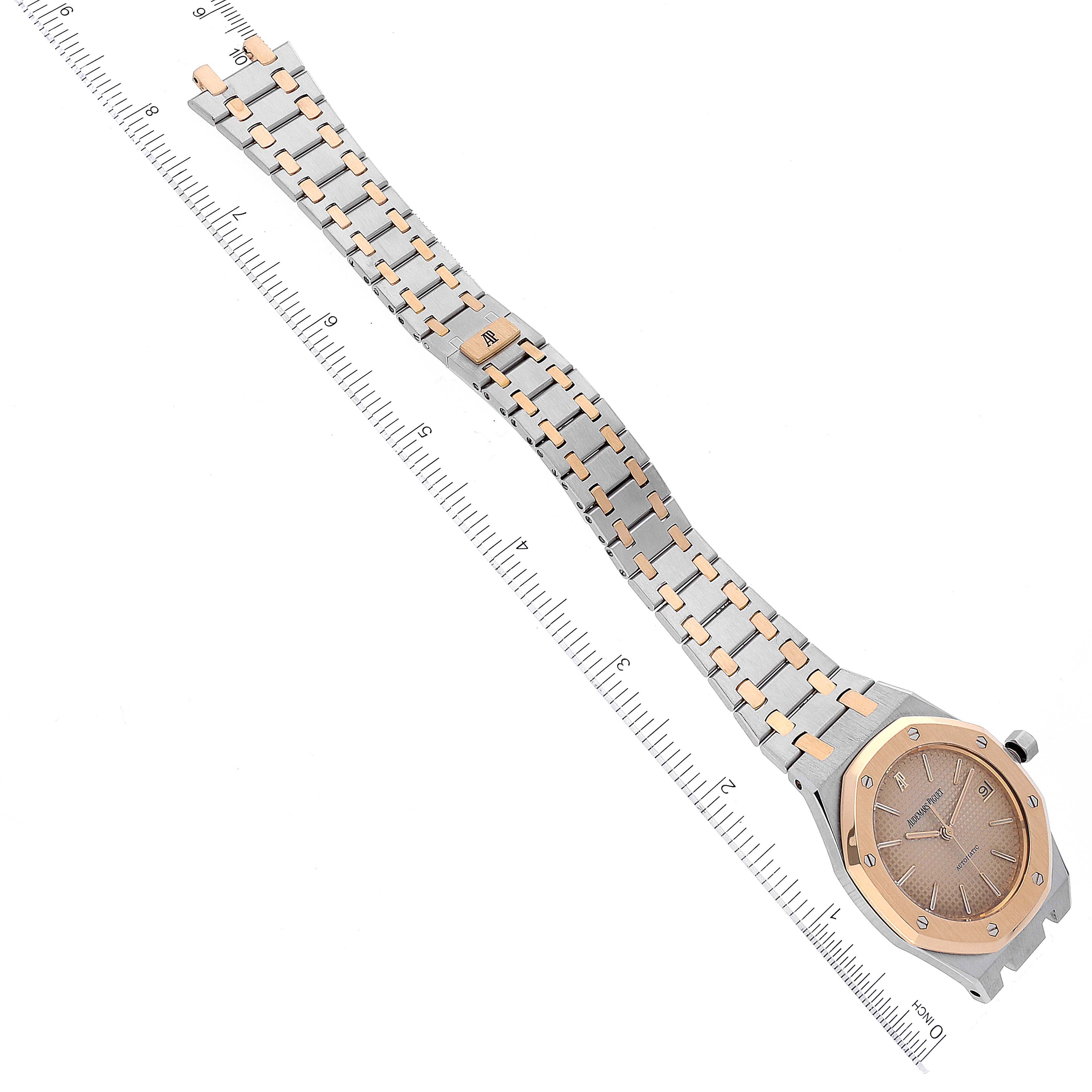 The image shows a top-down view of the Audemars Piguet Royal Oak 4790/789 Men's Steel and Gold (two tone) Champagne Dial 4790/789 Men's Steel and Gold (two tone) Champagne Dial watch, featuring its two-tone bracelet and dial alongside a ruler for scale.