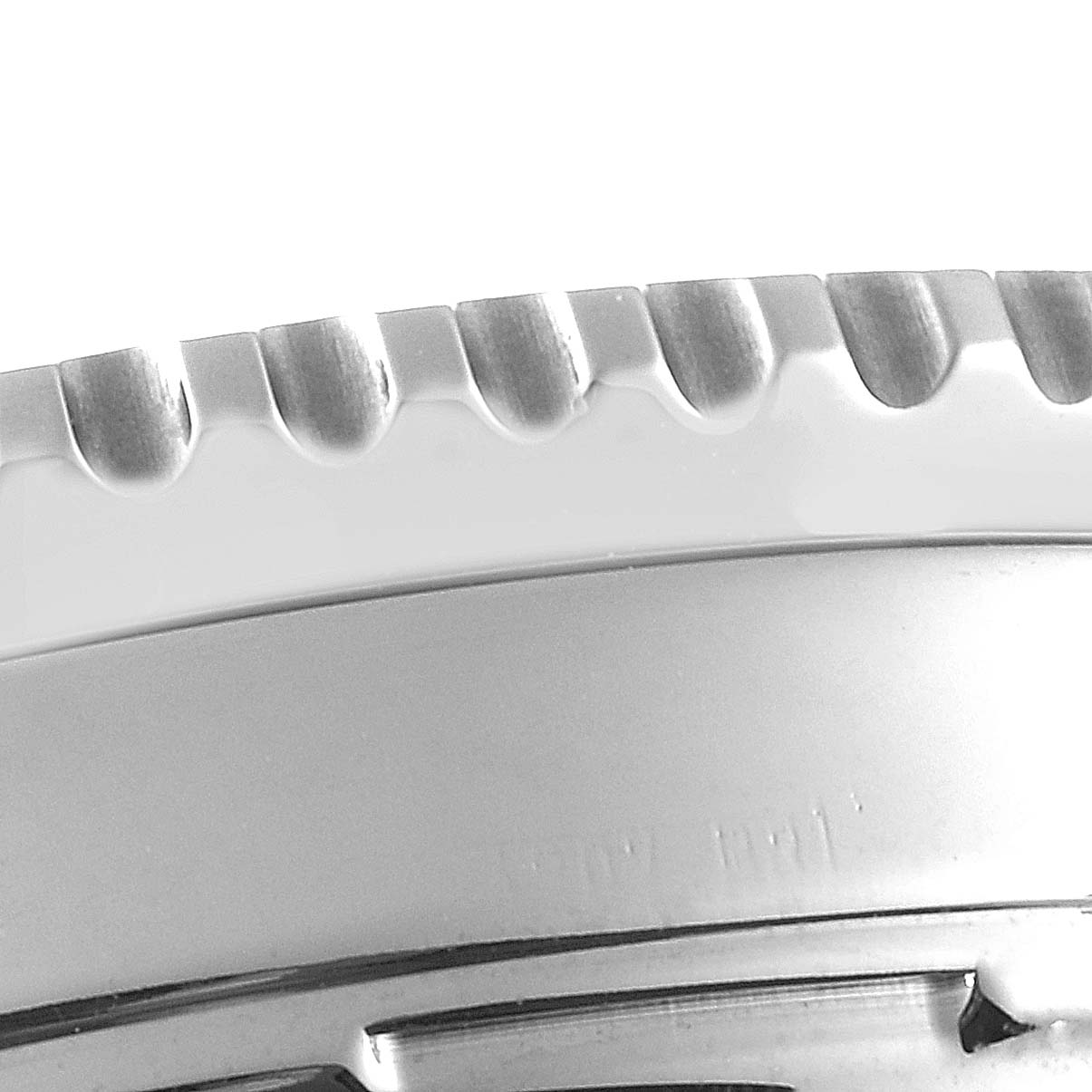 The image shows a close-up of the brushed metal bezel on a Breitling Navitimer A23322 Men's Stainless Steel Silver Dial A23322 Men's Stainless Steel Silver Dial watch, focusing on its knurled edge.