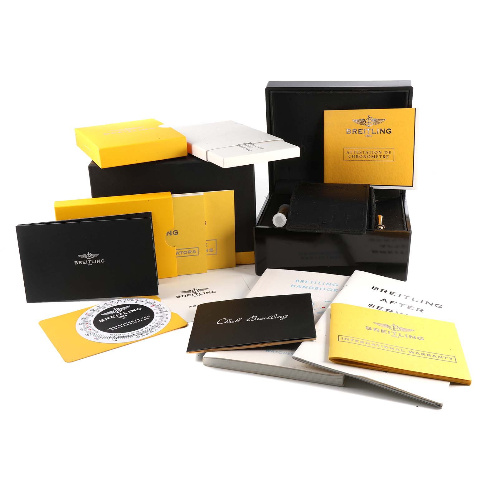 The image shows boxes, manuals, warranty cards, and a slide rule for the Breitling Navitimer A21330 Men's Stainless Steel Silver Dial A21330 Men's Stainless Steel Silver Dial watch model.