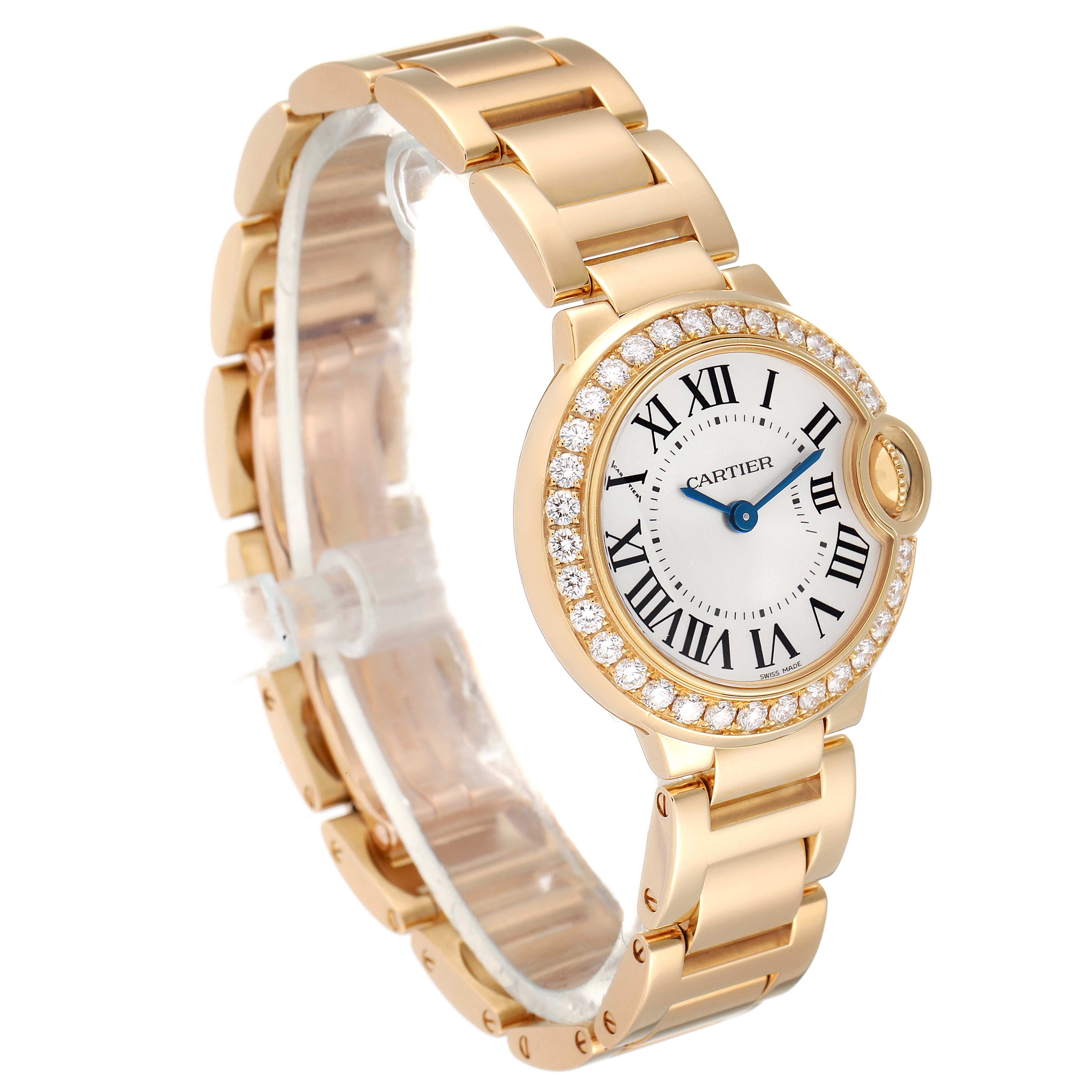 The image shows a Cartier Ballon Bleu WE9001Z3 Women's Yellow Gold Silver Dial WE9001Z3 Women's Yellow Gold Silver Dial watch angled to display the face, bracelet, and diamond-studded bezel.