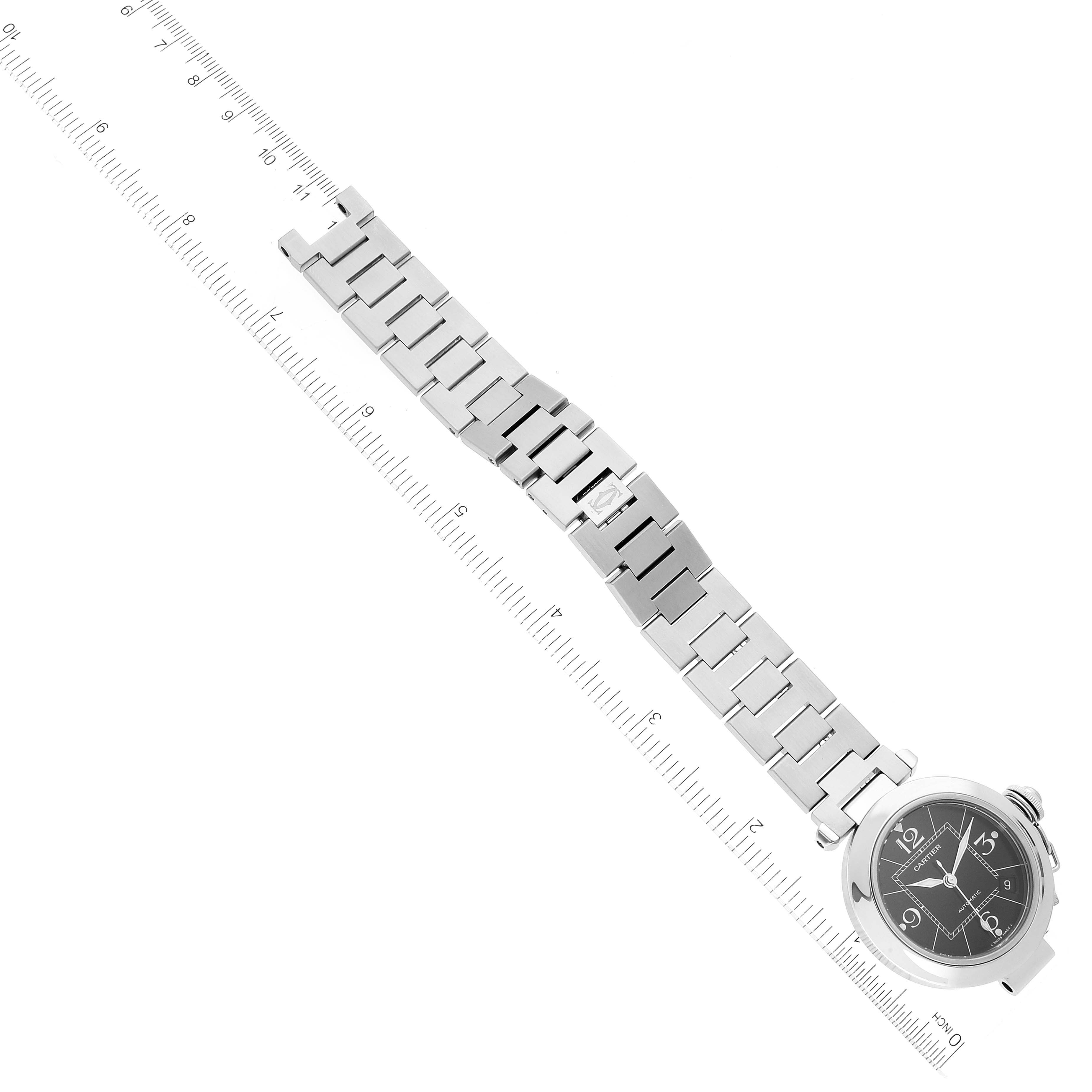 The image shows a Cartier Pasha W31076M7 Women's Stainless Steel Black Dial W31076M7 Women's Stainless Steel Black Dial watch laid flat with its face and metal bracelet fully visible, aligned with a ruler for size reference.