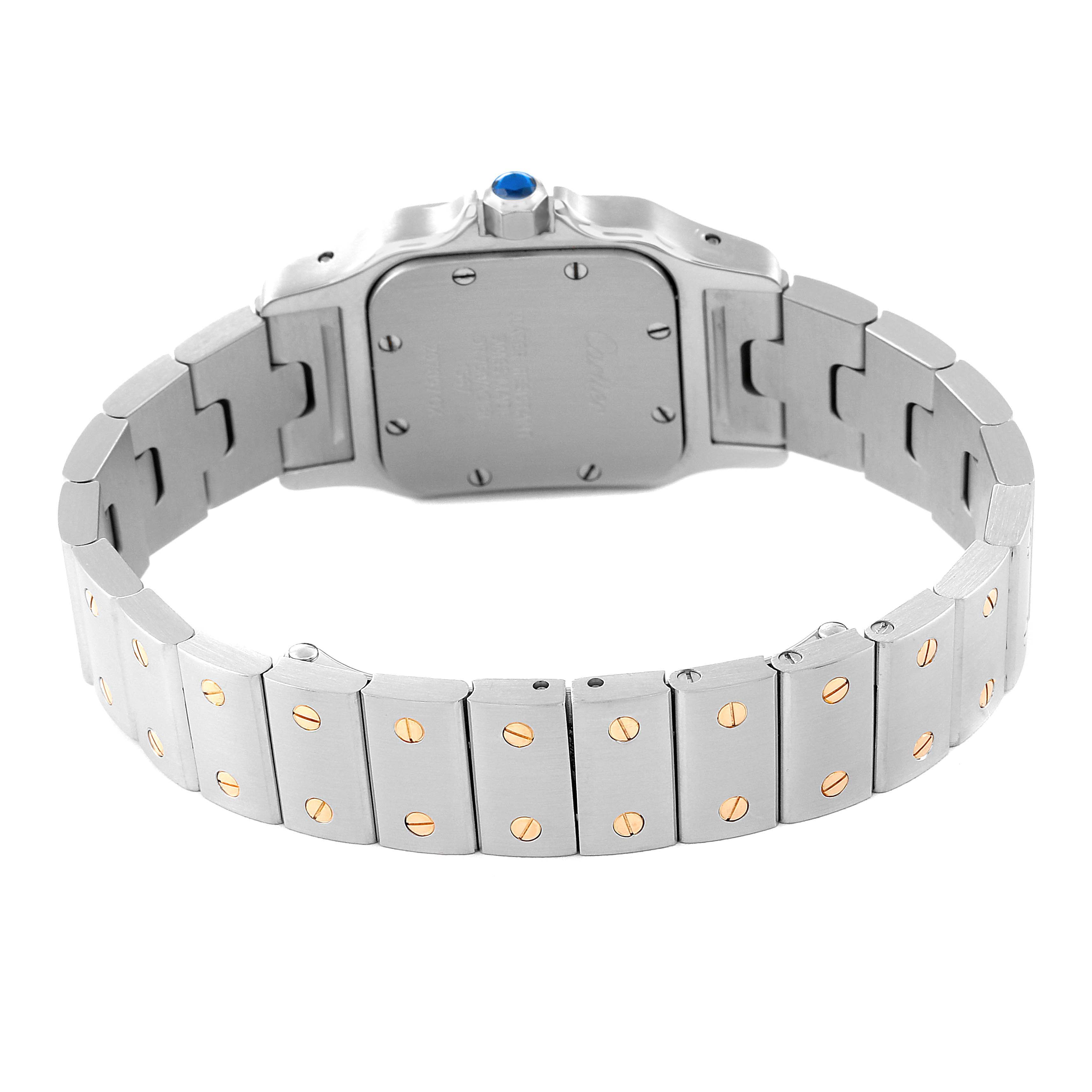 The image shows a rear view of a Cartier Santos W20012C4 Women's Steel and Gold (two tone) Silver Dial W20012C4 Women's Steel and Gold (two tone) Silver Dial watch highlighting the stainless steel bracelet with gold screws and the case back.