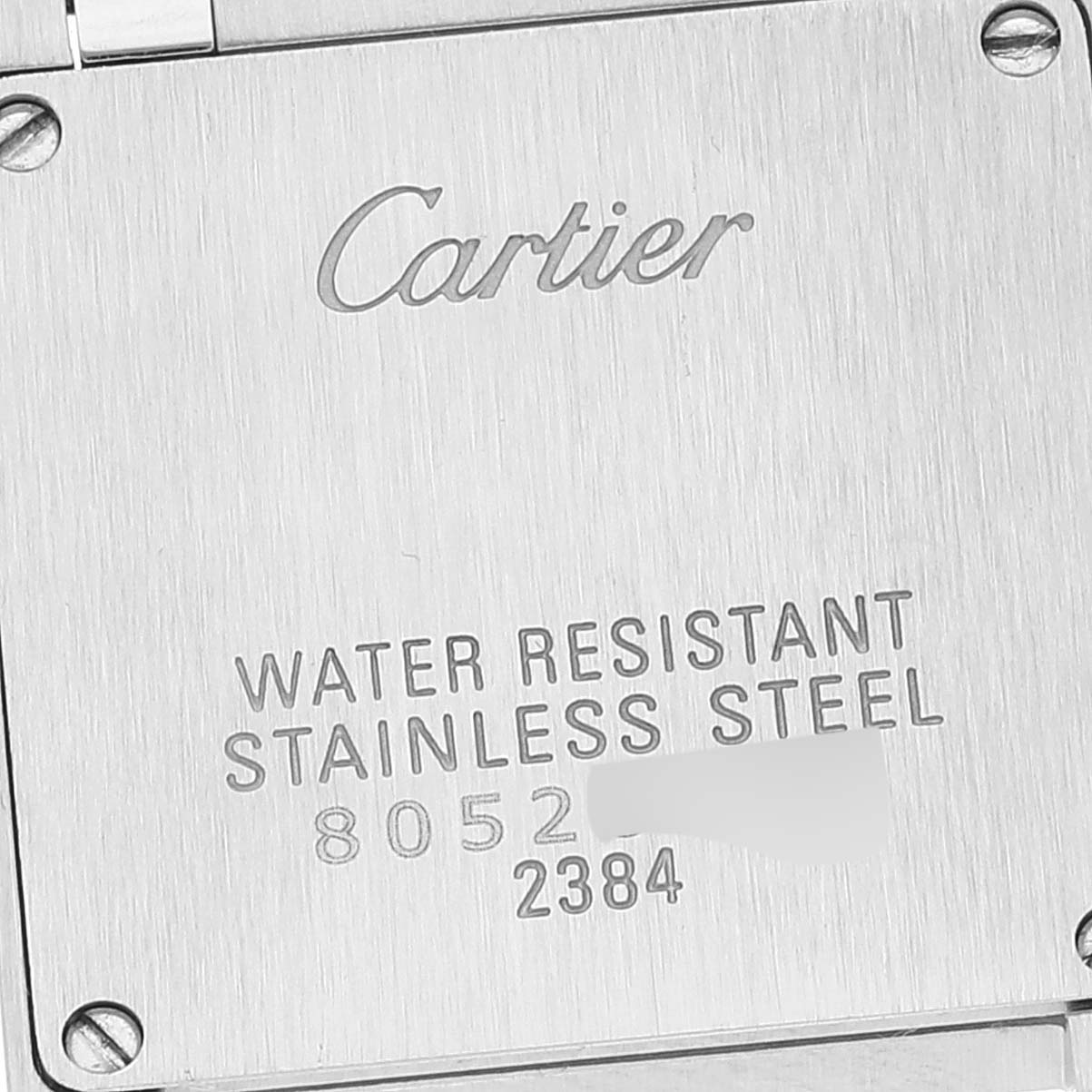 The image shows the stainless steel case back of a Cartier Tank Française watch, displaying the brand, model, and water resistance details.