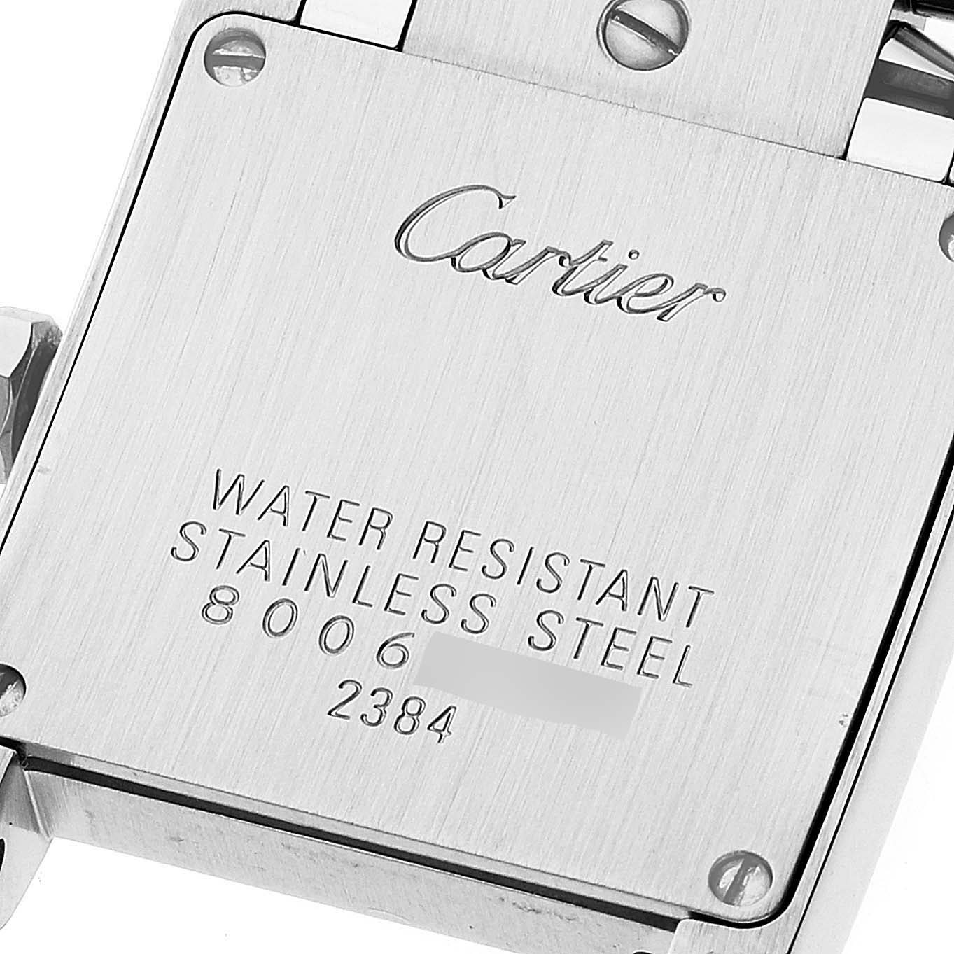 The image shows the back plate of a Tank Française watch by Cartier, highlighting the inscriptions and material.