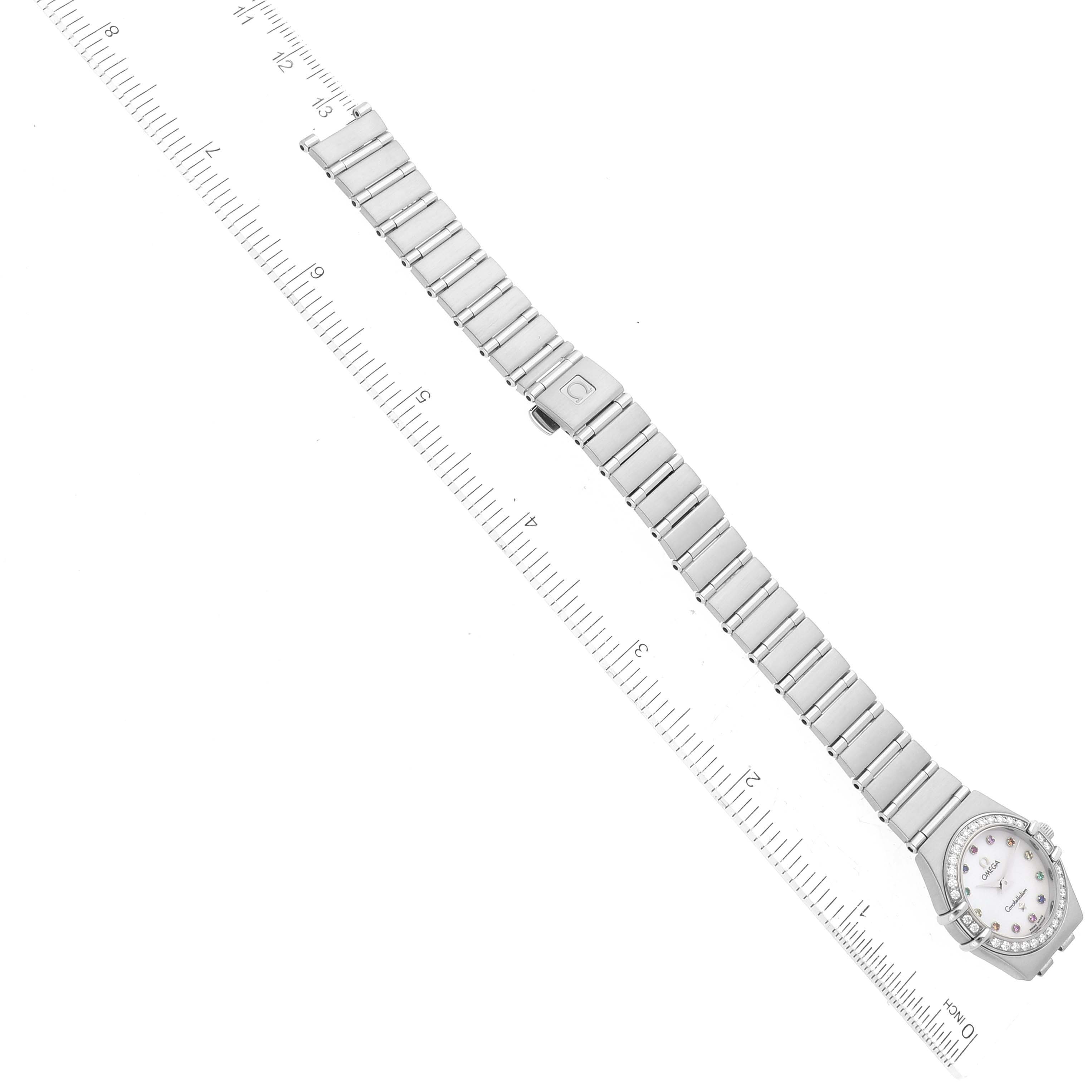 The image shows an Omega 1465.79.00 Women's Stainless Steel Mother of Pearl Dial 1465.79.00 Women's Stainless Steel Mother of Pearl Dial Constellation Iris Mother of Pearl Diamond Steel Ladies Watch 1465.79.00 laid flat with a ruler for scale.