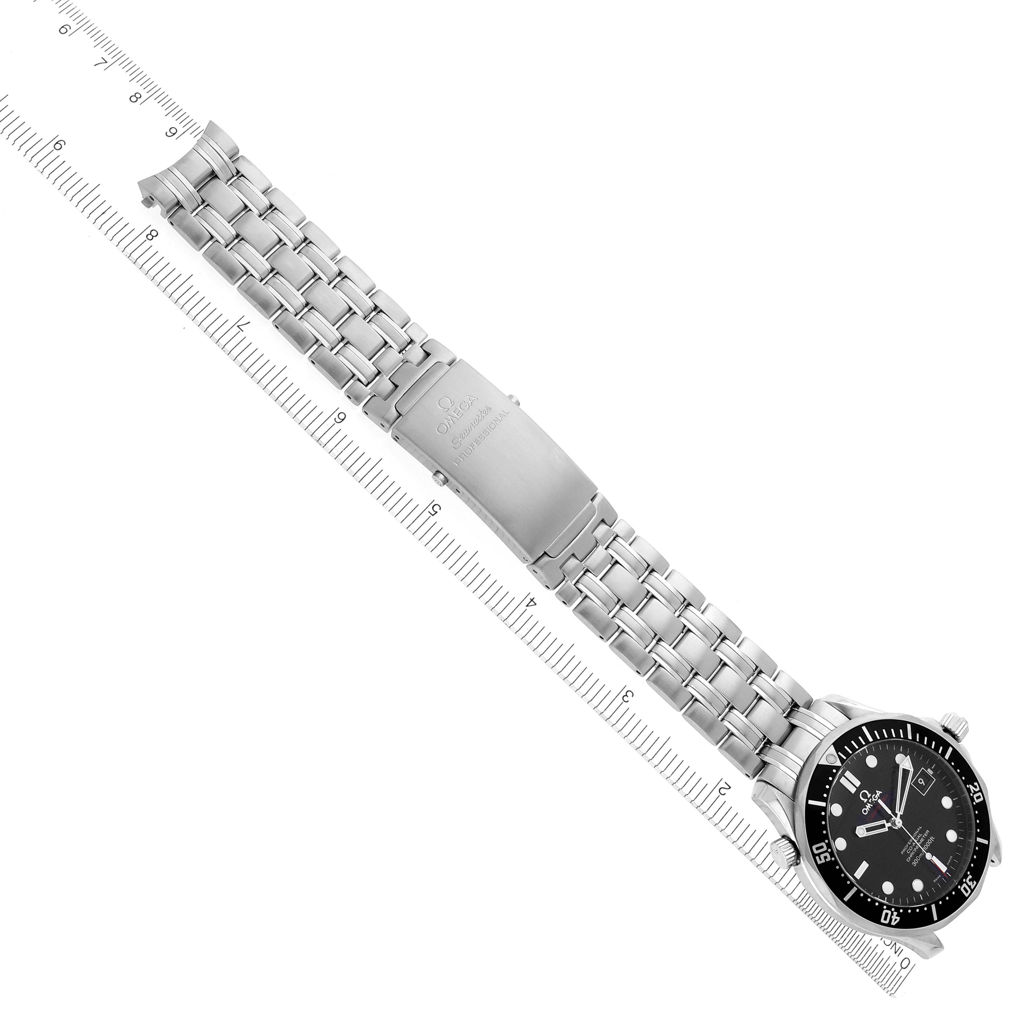 The Omega Seamaster 212.30.41.20.01.002 Men's Stainless Steel Black Dial 212.30.41.20.01.002 Men's Stainless Steel Black Dial watch is displayed from a top-down angle, showing the bracelet and watch face alongside a ruler for scale.