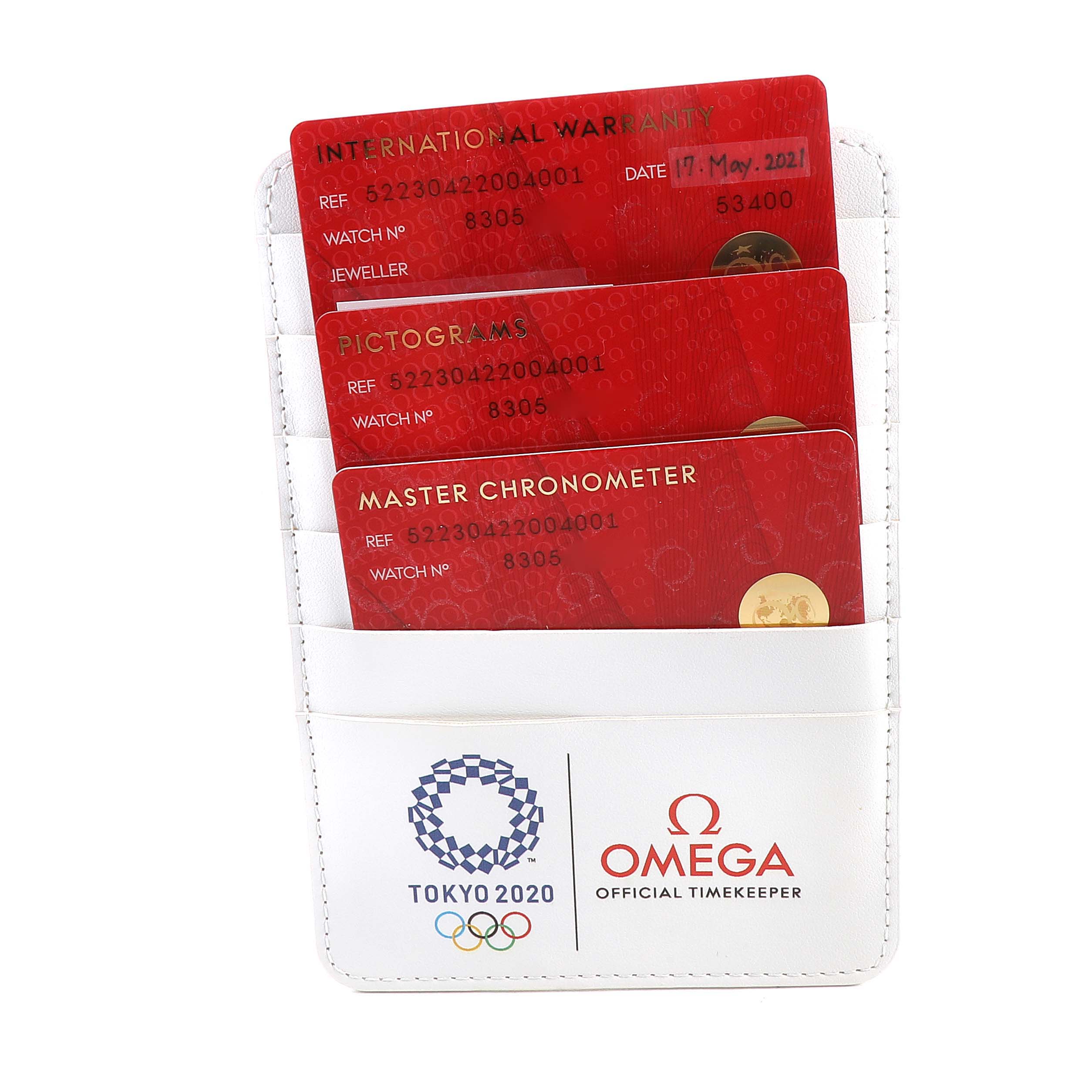 This image shows warranty and certification cards for the Omega Seamaster 522.30.42.20.04.001 Men's Stainless Steel White Dial 522.30.42.20.04.001 Men's Stainless Steel White Dial watch, displayed in a white holder.