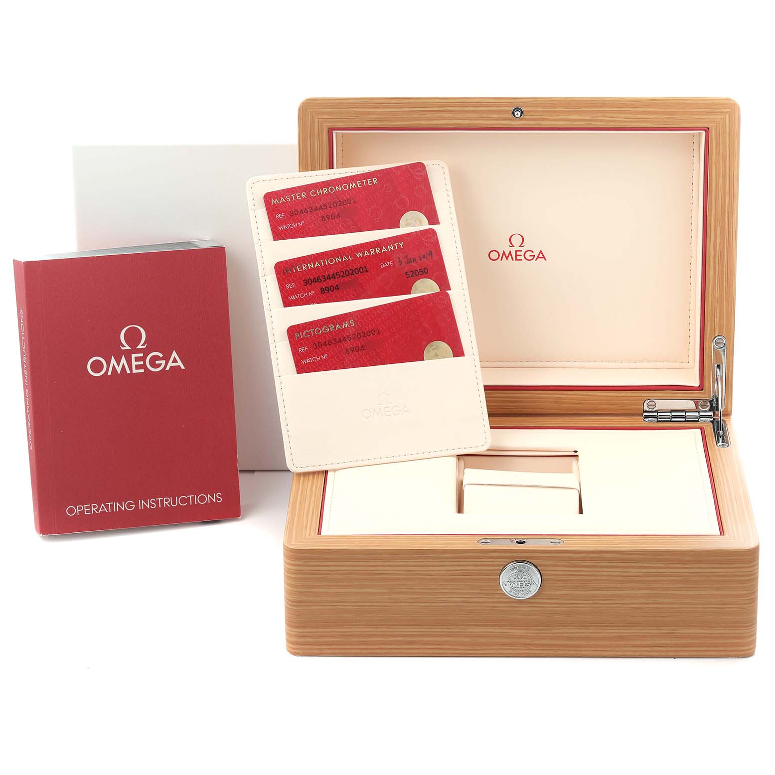 The image shows the Omega Speedmaster 304.63.44.52.02.001 Men's Yellow Gold Silver Dial 304.63.44.52.02.001 Men's Yellow Gold Silver Dial box, warranty cards, and operating manual from a front angle.