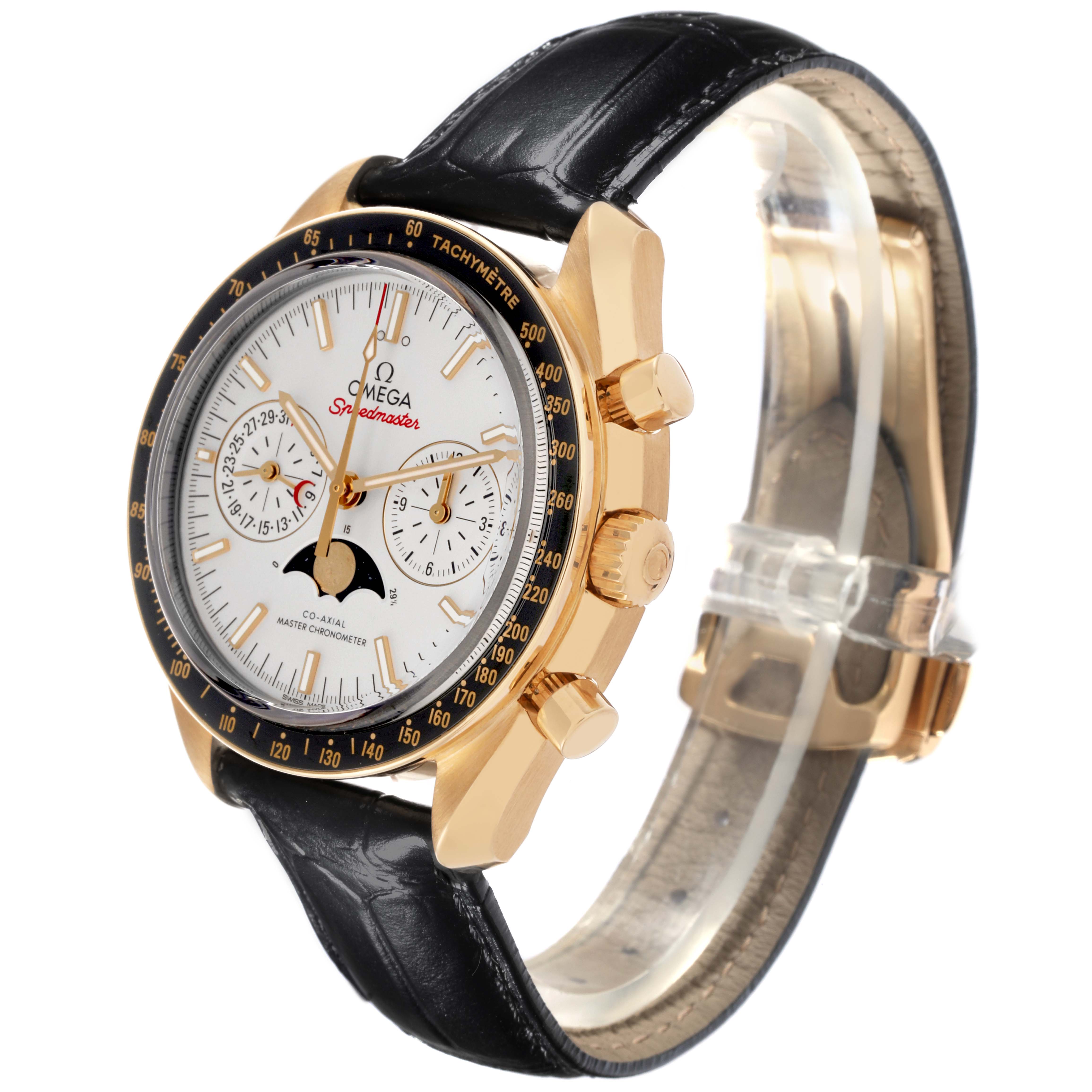 The Omega Speedmaster 304.63.44.52.02.001 Men's Yellow Gold Silver Dial 304.63.44.52.02.001 Men's Yellow Gold Silver Dial watch is shown from a side angle, highlighting the bezel, crown, chronograph, and leather strap.