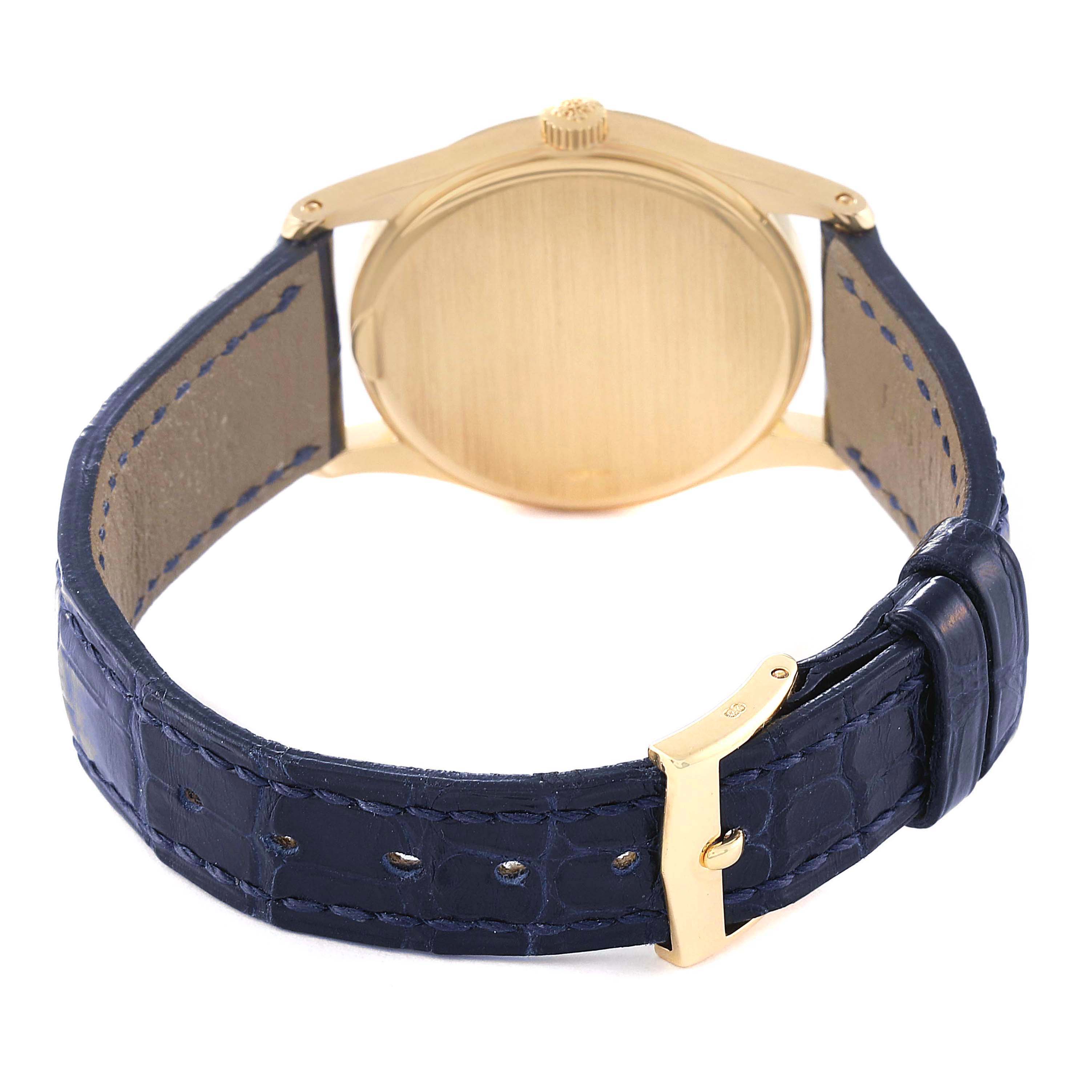 The image shows the back case, crown, and blue leather strap of the Patek Philippe Calatrava 3796 Men's Yellow Gold Silver Dial 3796 Men's Yellow Gold Silver Dial watch.