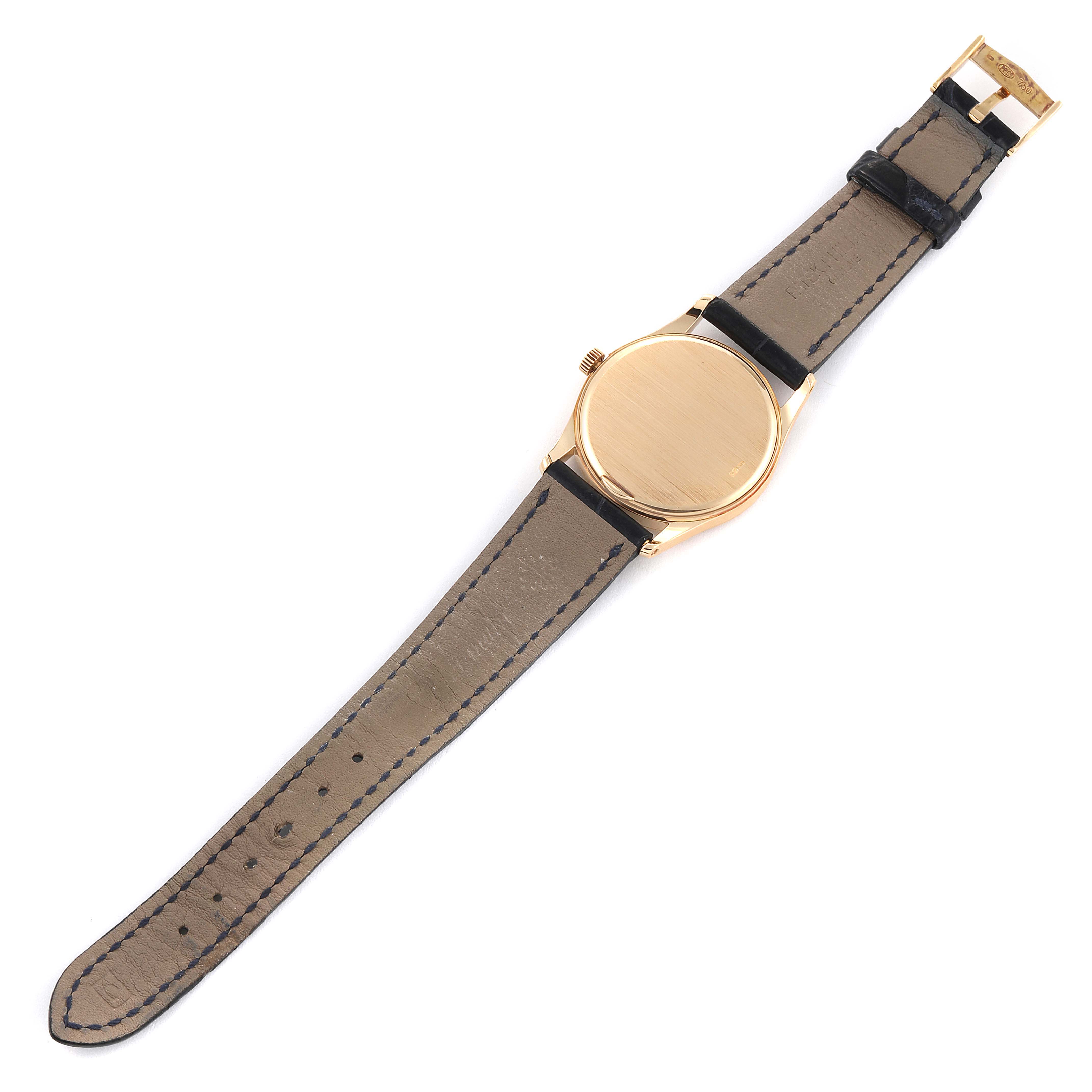 The image shows the back view of a Patek Philippe Calatrava 3796 Men's Yellow Gold Silver Dial 3796 Men's Yellow Gold Silver Dial watch, including its case and leather strap.