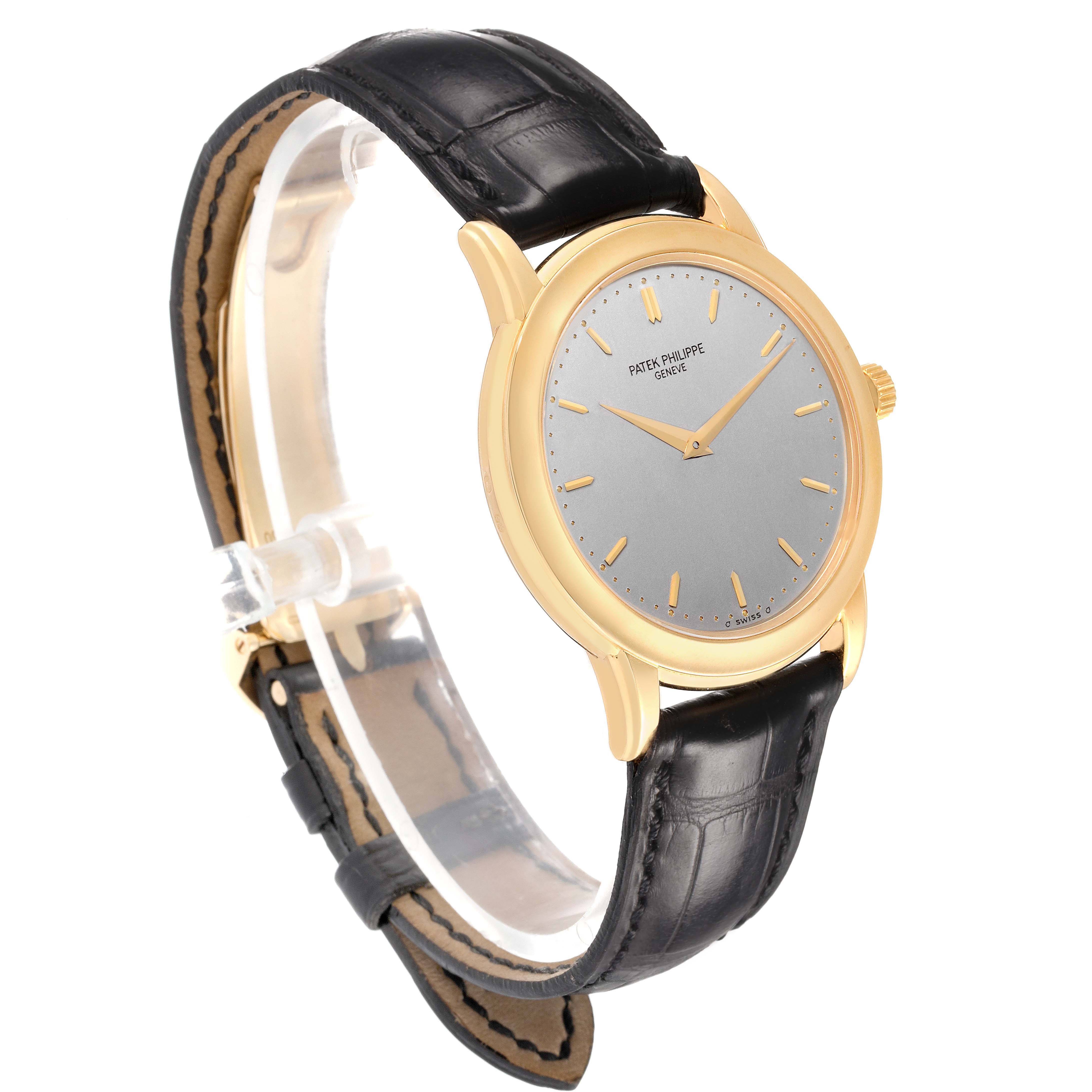 The Patek Philippe Calatrava 5032J Men's Yellow Gold Silver Dial watch is shown at a three-quarter angle, displaying the dial, case, crown, and strap clearly.