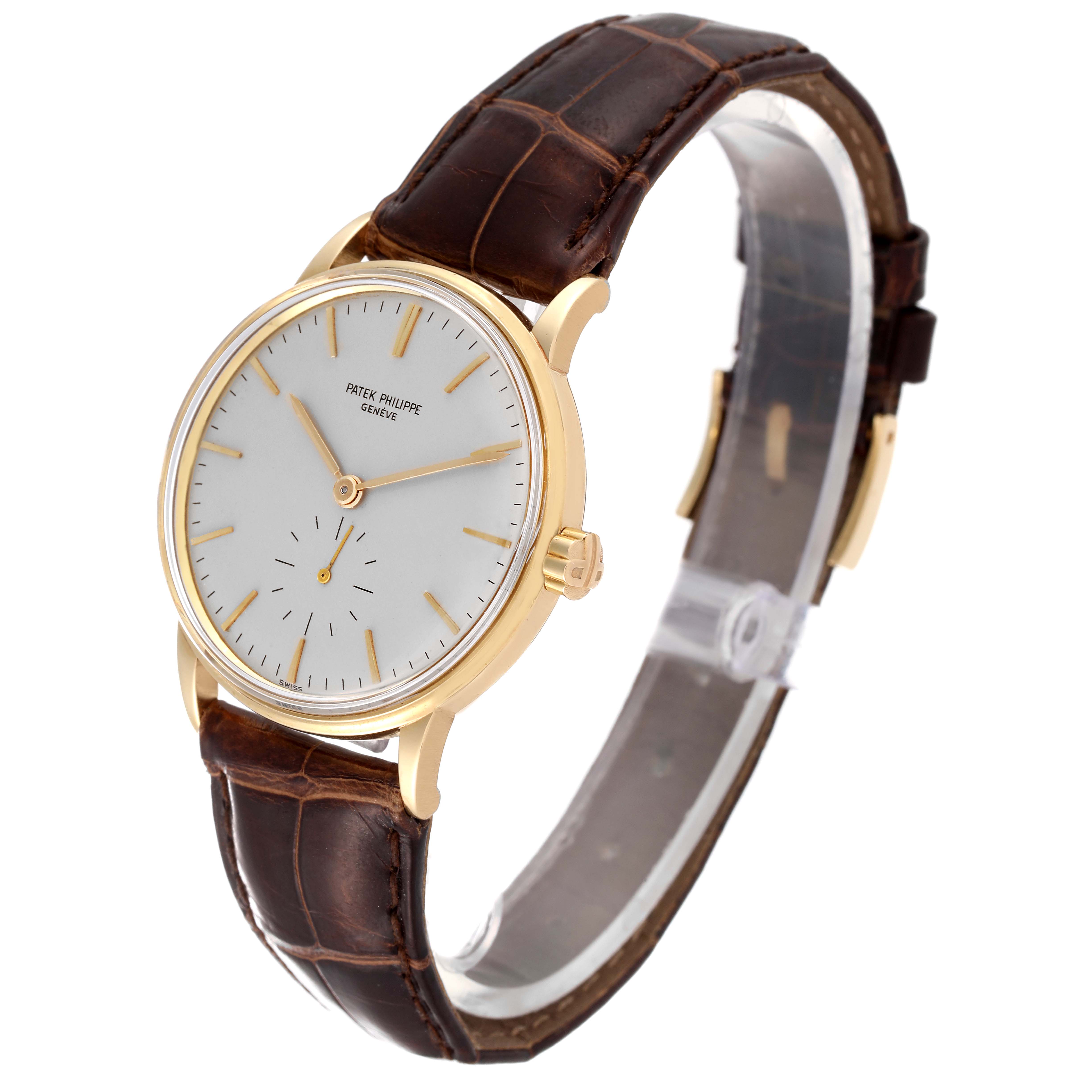 The image shows a side angle view of the Patek Philippe Calatrava 3425 Men's Yellow Gold Silver Dial 3425 Men's Yellow Gold Silver Dial watch, including its face, case, and leather strap.