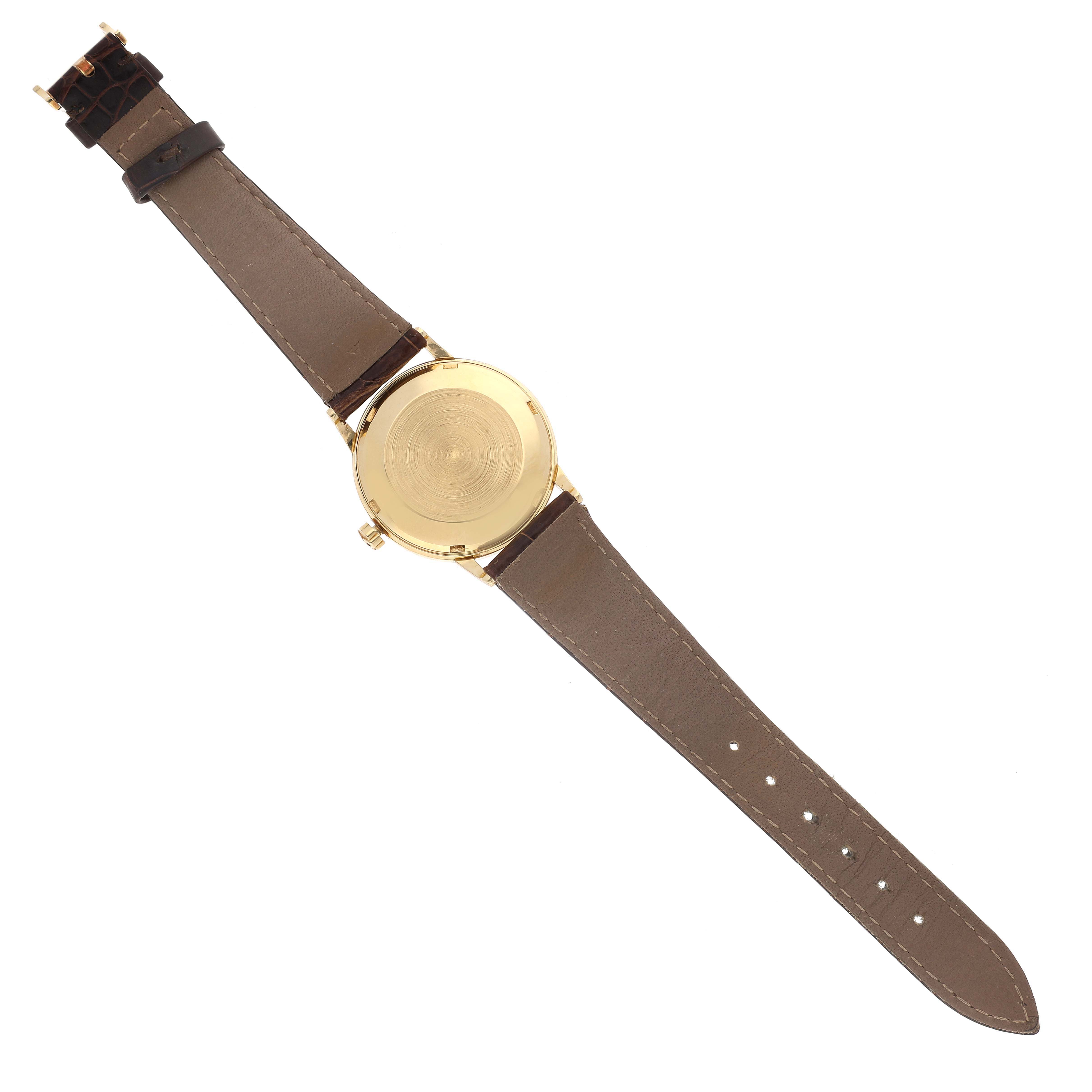 The image shows the back view of a Patek Philippe Calatrava 3425 Men's Yellow Gold Silver Dial 3425 Men's Yellow Gold Silver Dial watch, displaying its case back and brown leather strap.