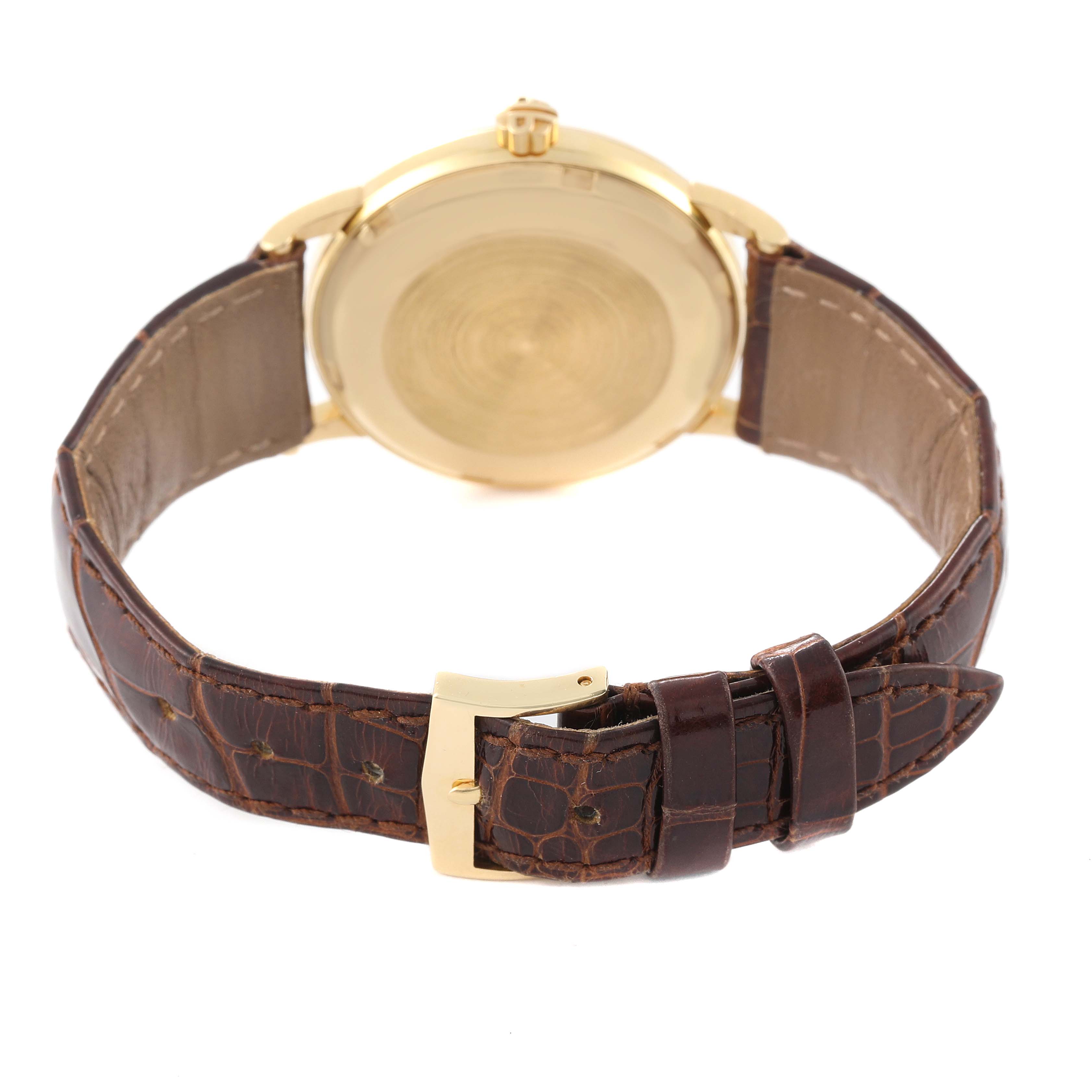 This image shows the back view of a Patek Philippe Calatrava 3425 Men's Yellow Gold Silver Dial 3425 Men's Yellow Gold Silver Dial watch, highlighting its leather strap and gold clasp.