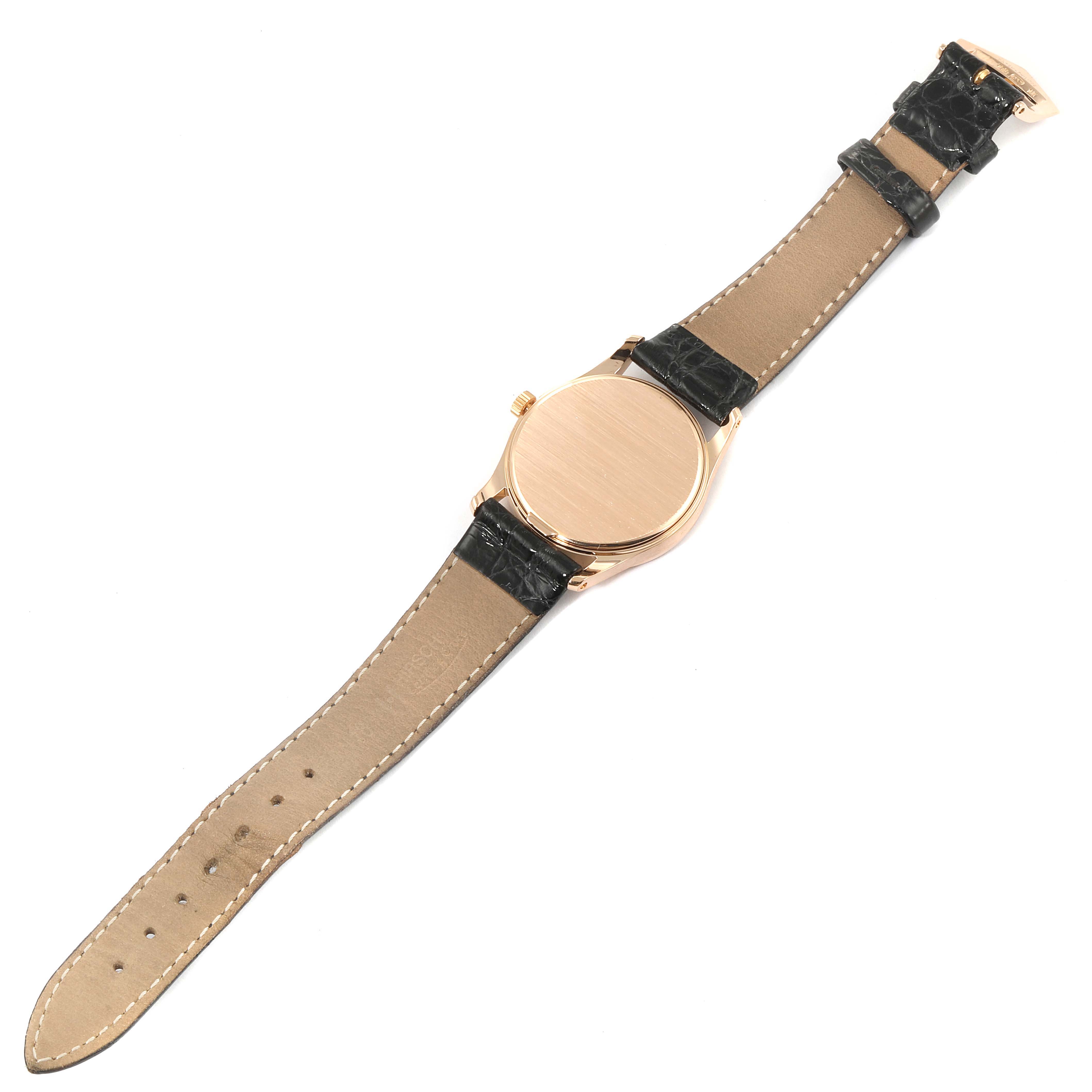 The image shows the underside of a Patek Philippe Calatrava 3796R Men's Rose Gold Silver Dial 3796R Men's Rose Gold Silver Dial watch, revealing its leather straps and case back.
