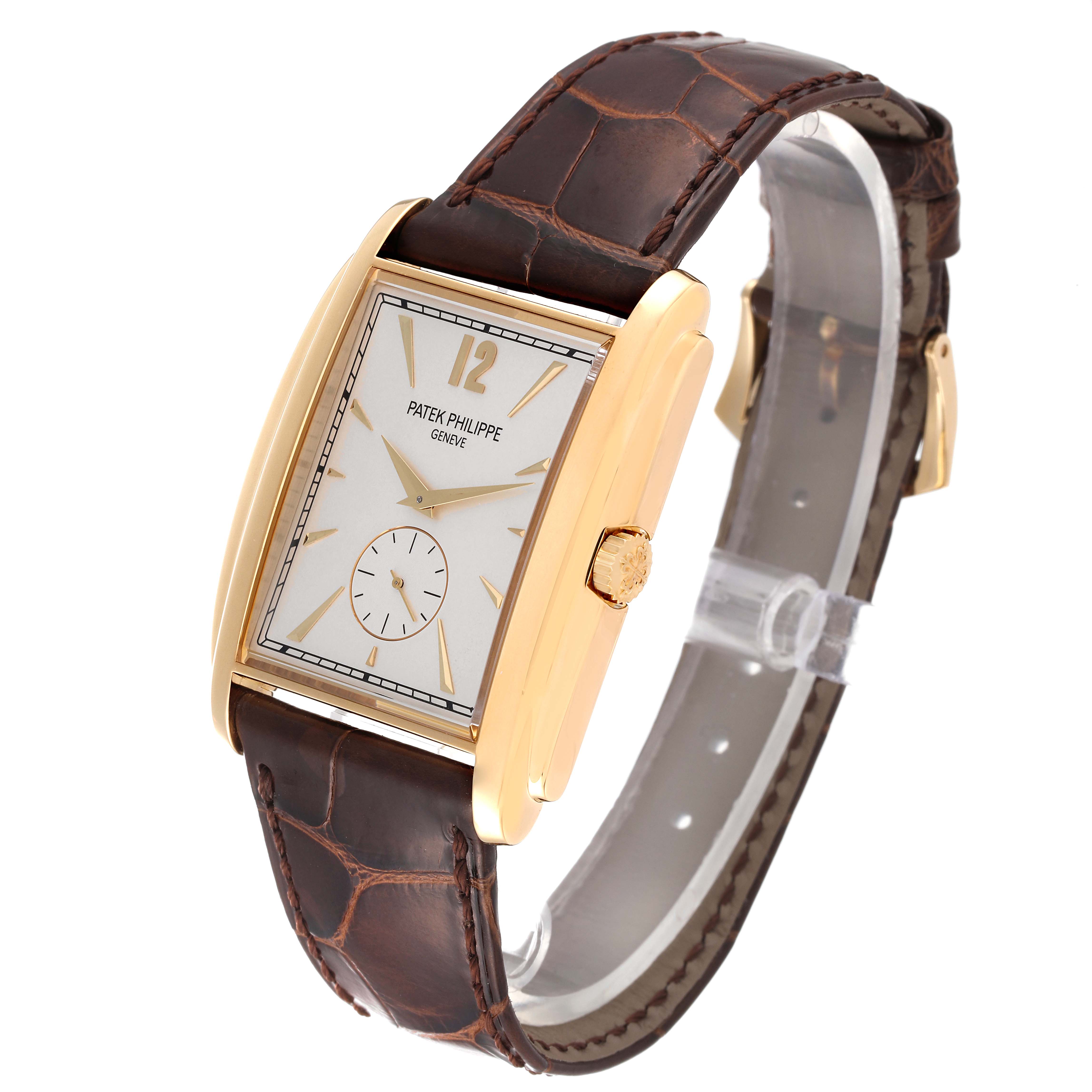 The image shows a Patek Philippe Gondolo 5124J Men's Yellow Gold Silver Dial 5124J Men's Yellow Gold Silver Dial watch angled to display its face, gold case, crown, and brown leather strap.