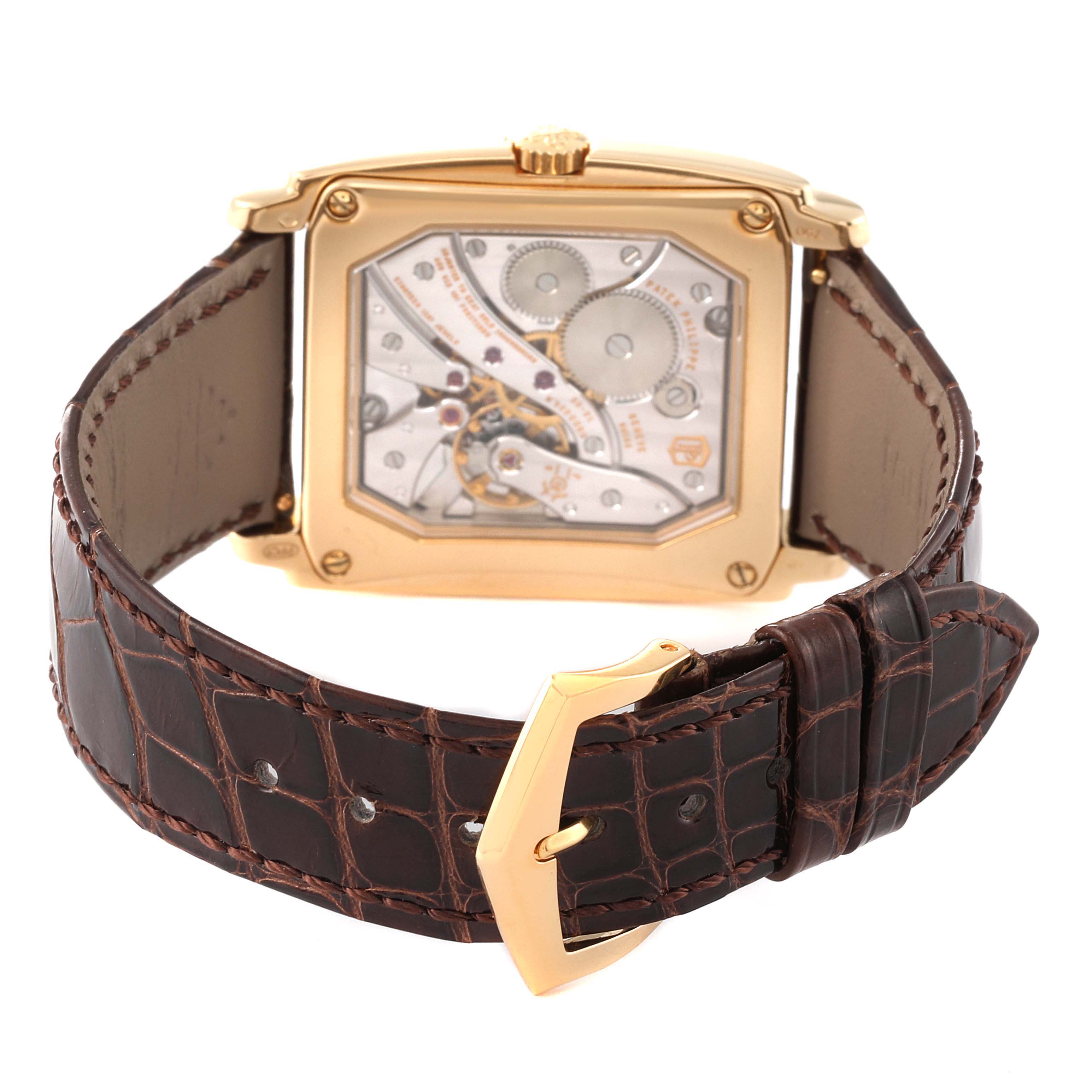 This image shows the back view of a Patek Philippe Gondolo 5124J Men's Yellow Gold Silver Dial 5124J Men's Yellow Gold Silver Dial watch, showcasing the movement and brown leather strap.