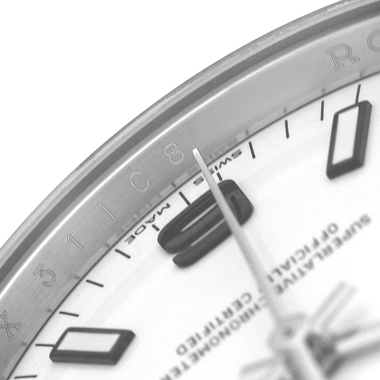 The image shows a close-up of a Rolex Air-King 114200 Men's Stainless Steel White Dial watch's dial, featuring the minute and second hands, and indices on the bezel.