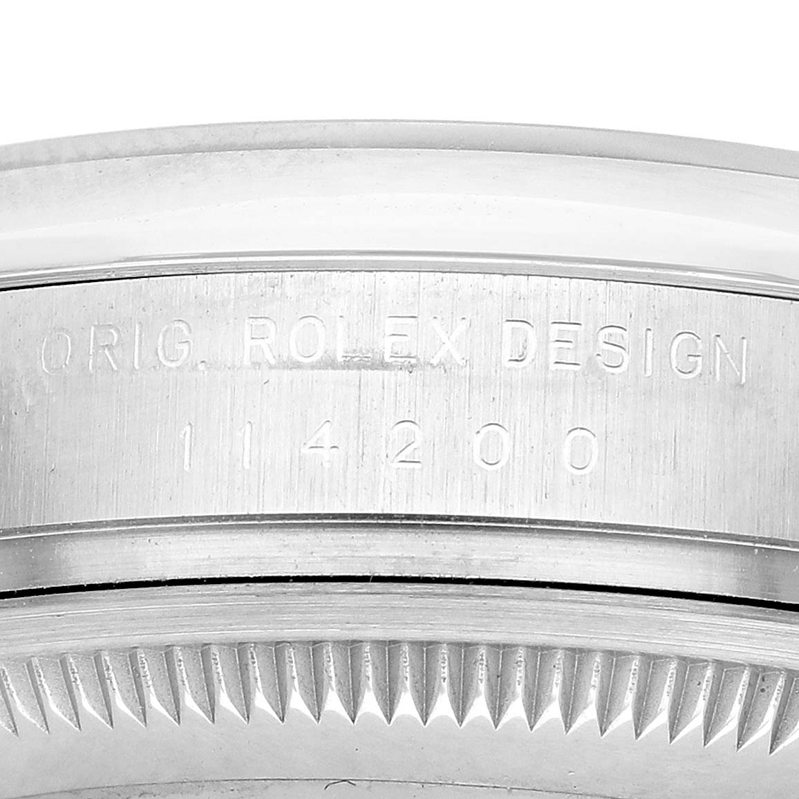 The image shows a close-up of the Rolex Air-King 114200 Men's Stainless Steel White Dial's case edge, highlighting the engraved design and reference number.