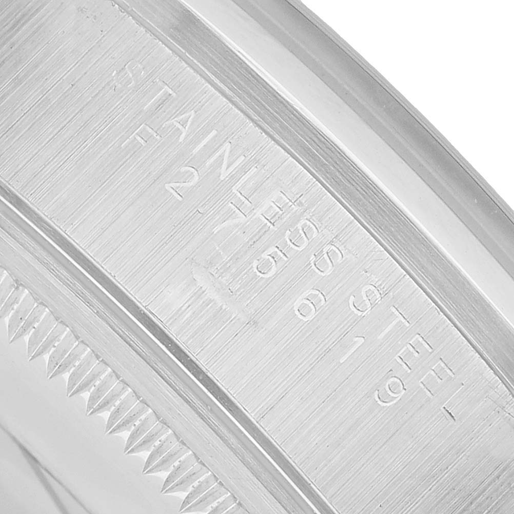 The image shows a close-up of the engraved caseback edge of a Rolex Air-King 14000 Men's Stainless Steel Black Dial watch.