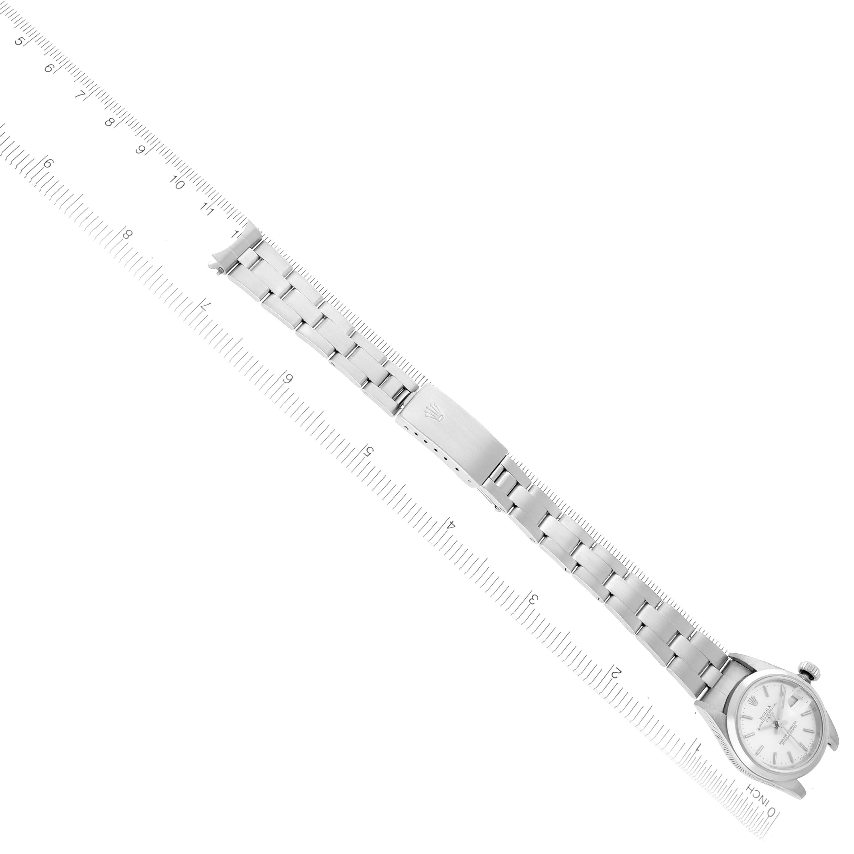 The Rolex Date 69160 Women's Stainless Steel Silver Dial 69160 Women's Stainless Steel Silver Dial watch is shown from an angled top-down perspective, displaying the face, bracelet, and clasp.