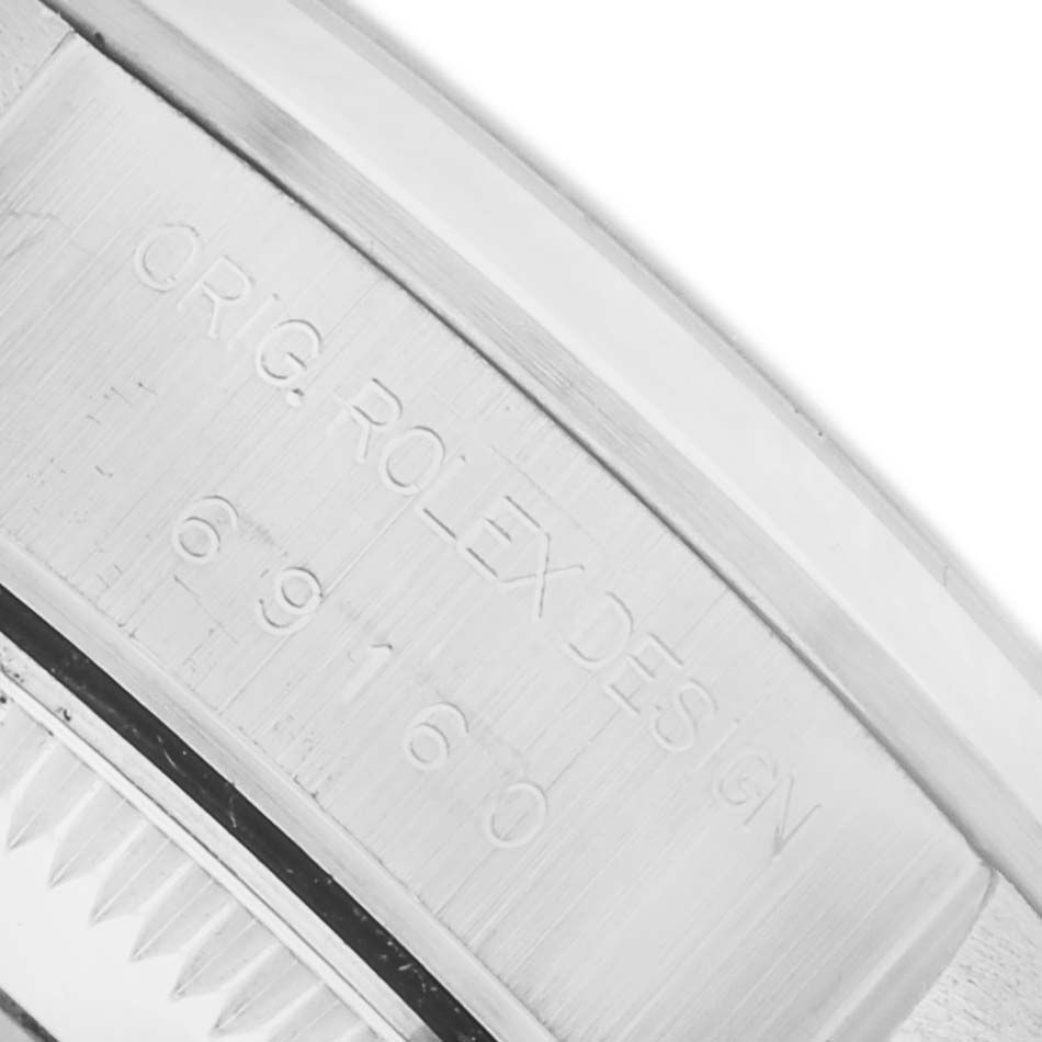 The image shows an angled close-up of the Rolex Date 69160 Women's Stainless Steel Silver Dial 69160 Women's Stainless Steel Silver Dial model's inner case with engraved details.