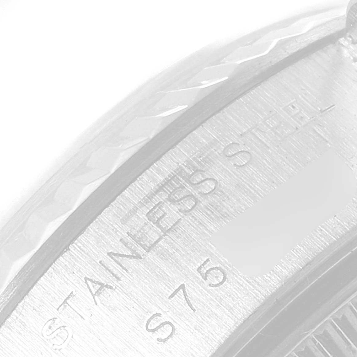 The image shows a close-up angle of the bezel and part of the case of a Rolex Datejust 69174 Women
s Stainless Steel Silver Dial 69174 Women
s Stainless Steel Silver Dial watch, highlighting the "STAINLESS STEEL" engraving.