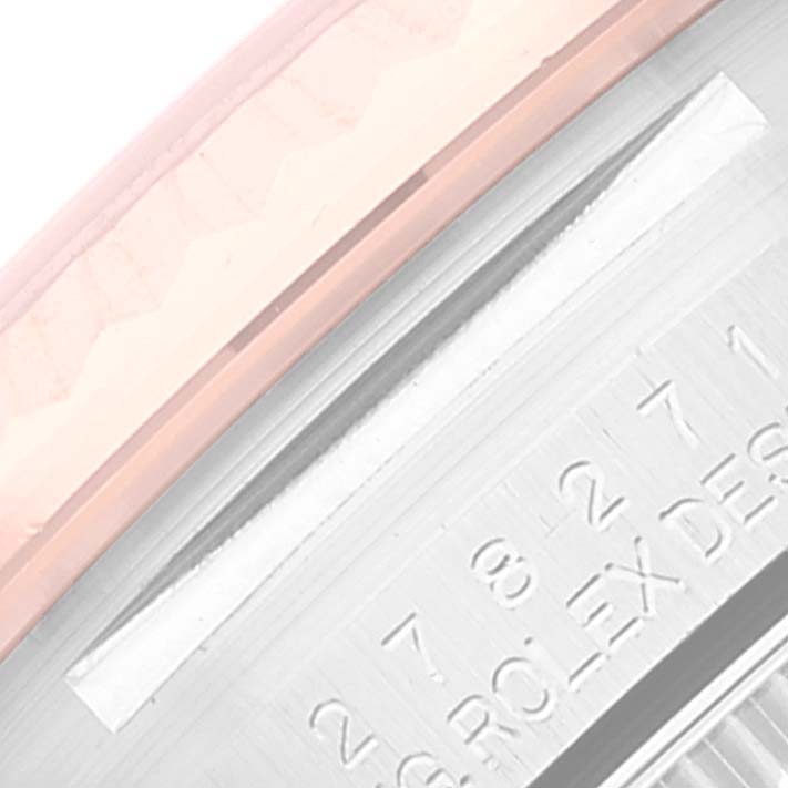 This close-up image shows the side profile of a Mid-Size Rolex watch, highlighting the bezel and some engraved text.