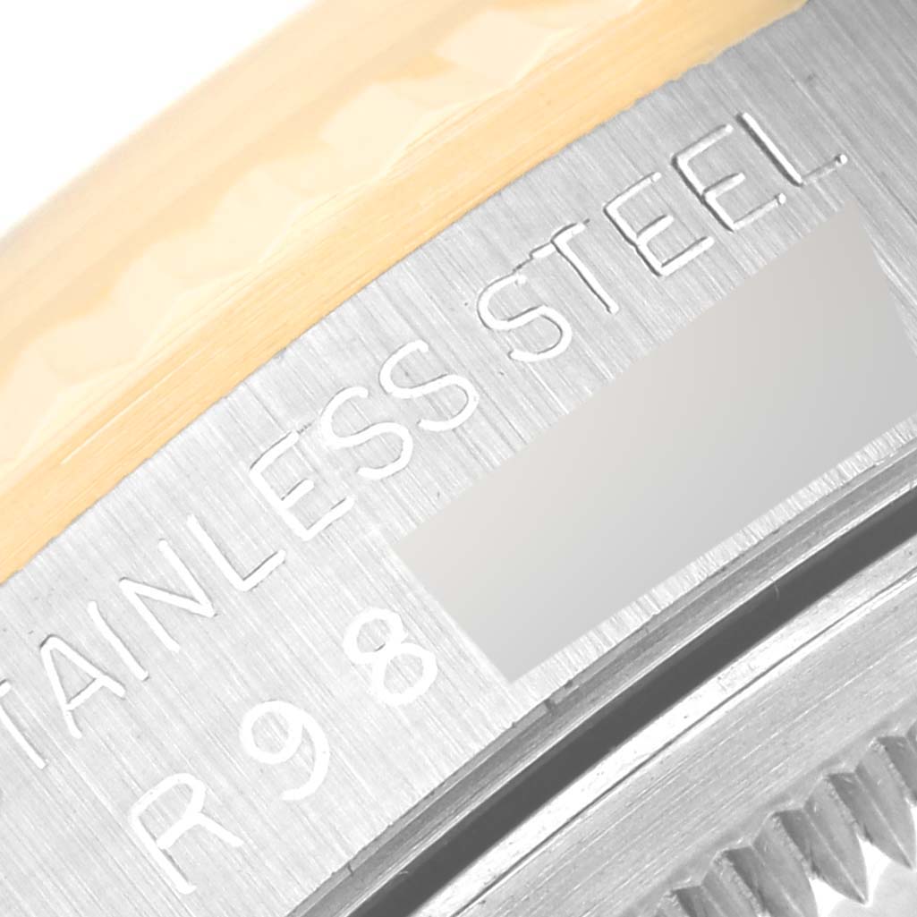 This image shows a close-up of the stainless steel case back and edge of the bezel of a Rolex Datejust 16233 Men's Steel and Gold (two tone) Silver Dial 16233 Men's Steel and Gold (two tone) Silver Dial watch.