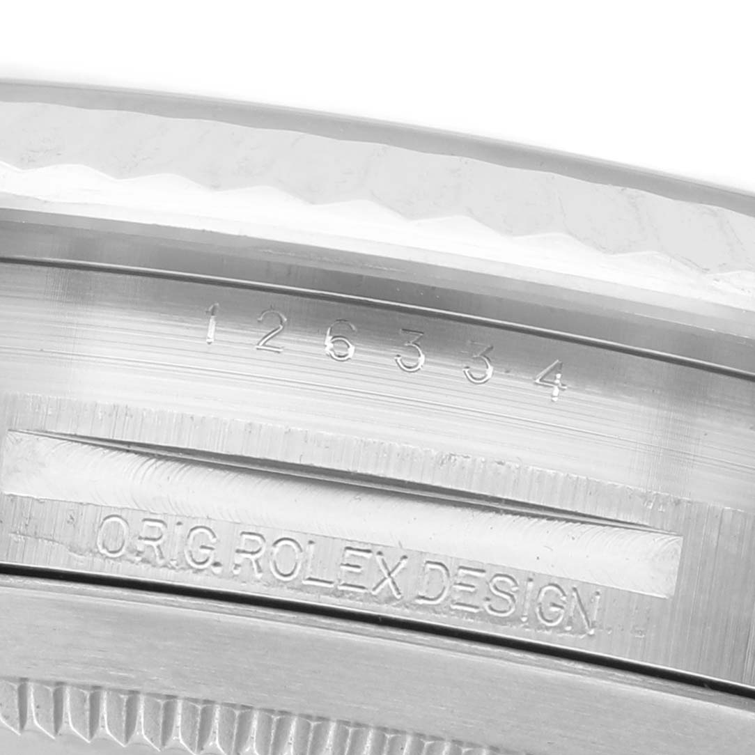 The image shows a detailed close-up of the watch's case side, featuring engravings of the model number and "ORIG. ROLEX DESIGN."