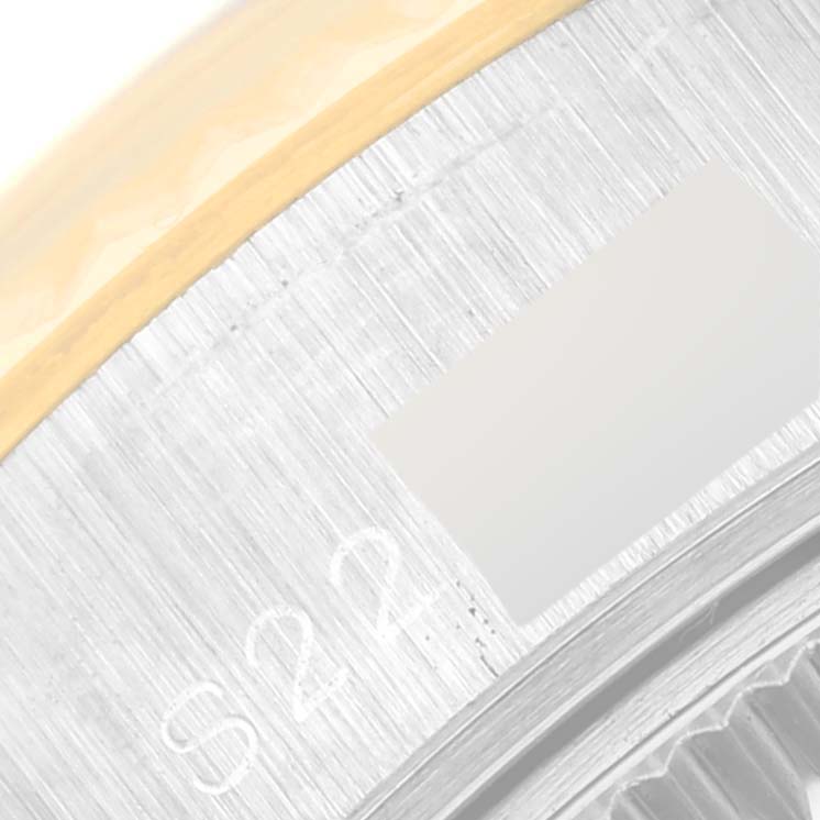 This image shows a close-up view of the side of a Rolex Datejust 69173 Women's Steel and Gold (two tone) Blue Dial 69173 Women's Steel and Gold (two tone) Blue Dial watch, including part of the bezel and case with visible engraving.