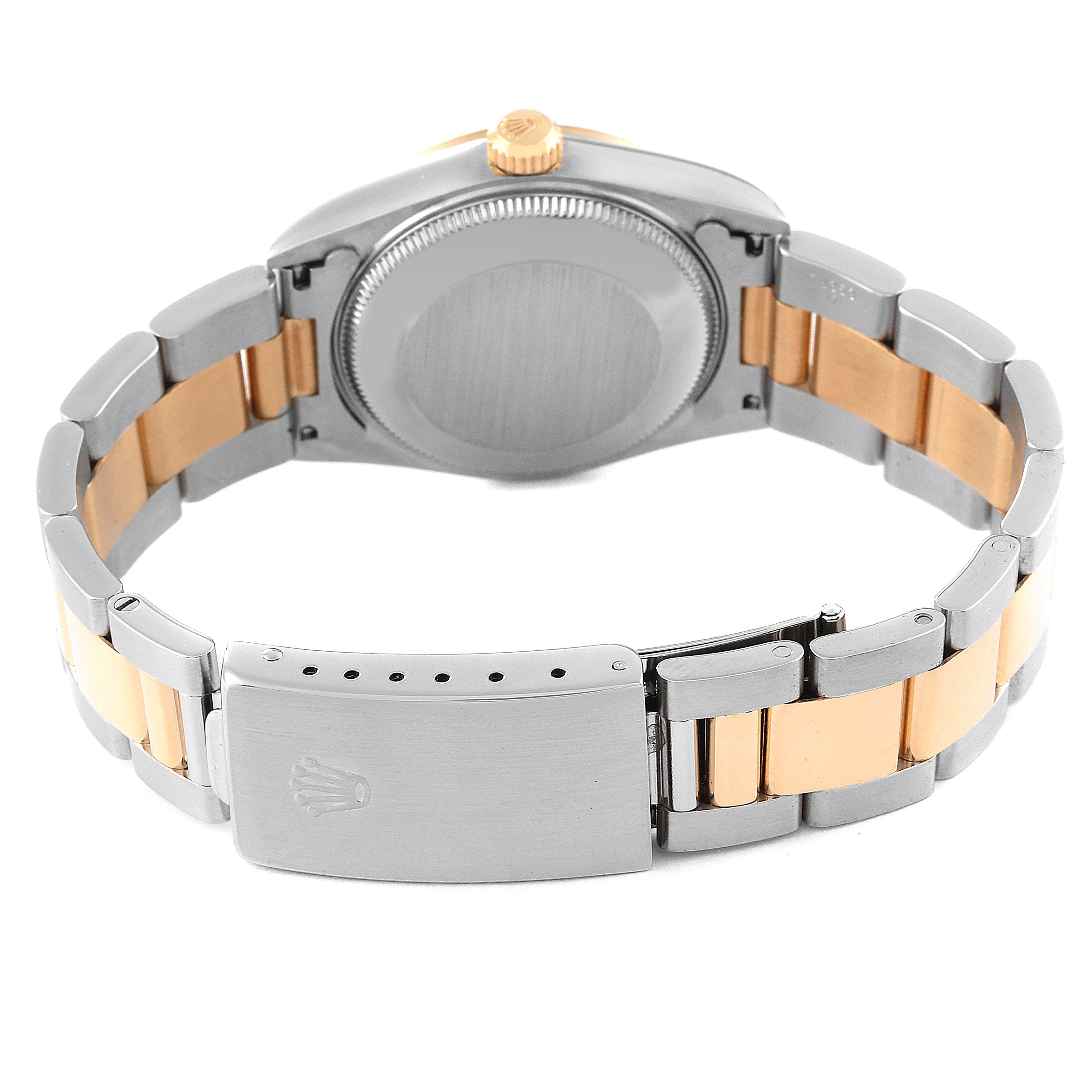 The image shows the back of a Rolex Mid-Size 68243 Women
s Steel and Gold (two tone) Black Dial 68243 Women
s Steel and Gold (two tone) Black Dial model watch, highlighting the case back, crown, and two-tone bracelet with clasp.