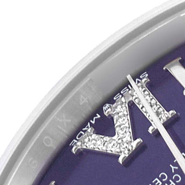 This close-up image shows the dial and diamond-set Roman numeral markers of a mid-size Rolex watch.