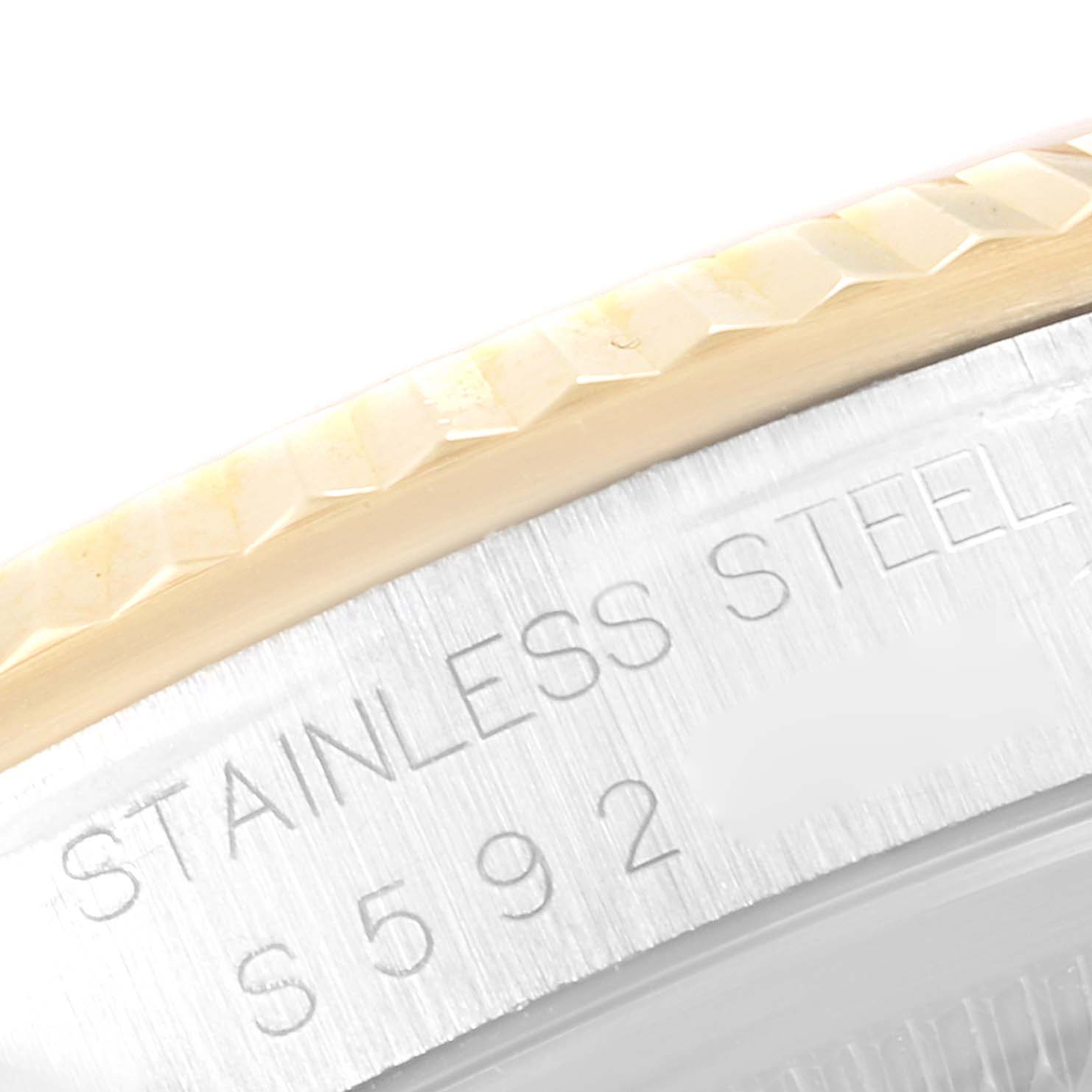 This image shows a close-up of the bezel and engraved text on the case of a Rolex Datejust 16233 Men's Steel and Gold (two tone) White Dial 16233 Men's Steel and Gold (two tone) White Dial watch.