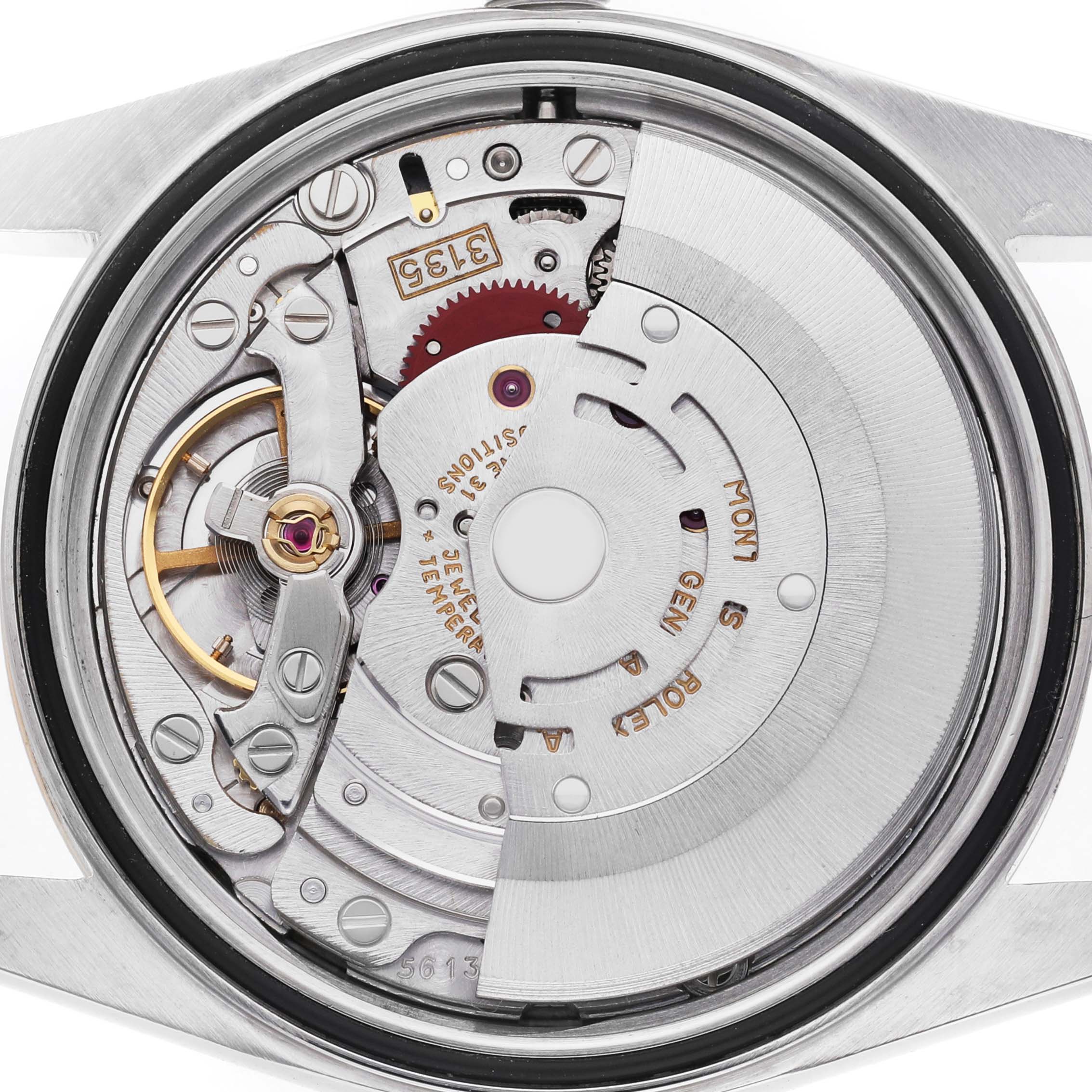 The image shows the Rolex Datejust 16233 Men's Steel and Gold (two tone) Blue Dial watch movement from a back angle, revealing the rotor, gears, and balance wheel.