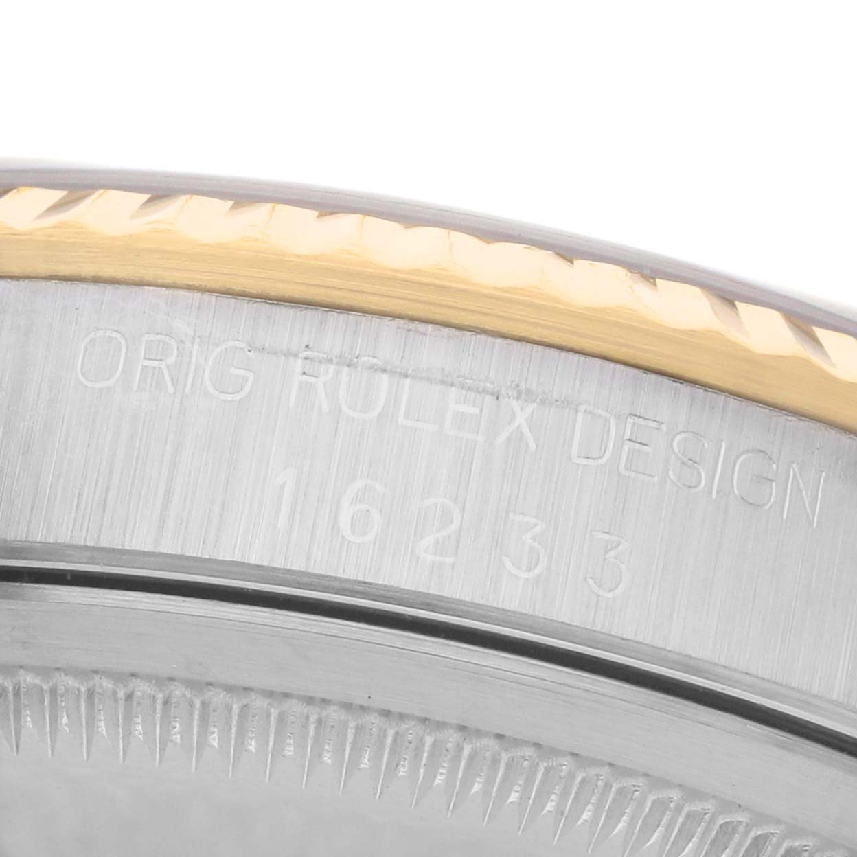 The image shows a partial view of a Rolex Datejust 16233 Men's Steel and Gold (two tone) Blue Dial watch bezel from a close-up angle, highlighting the engraved model number and design details.