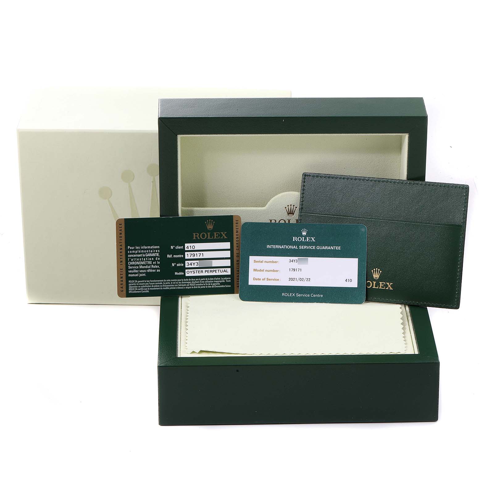 This image shows the accessories for a Rolex Datejust 179171 Women's Steel and Gold (two tone) Black Dial 179171 Women's Steel and Gold (two tone) Black Dial, including the box, guarantee card, and other documents.