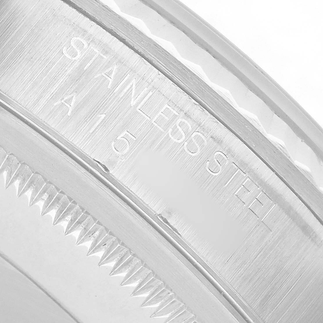 The image shows a close-up of the Rolex Datejust 16234 Men's Stainless Steel Blue Dial's stainless steel serrated bezel engraving.