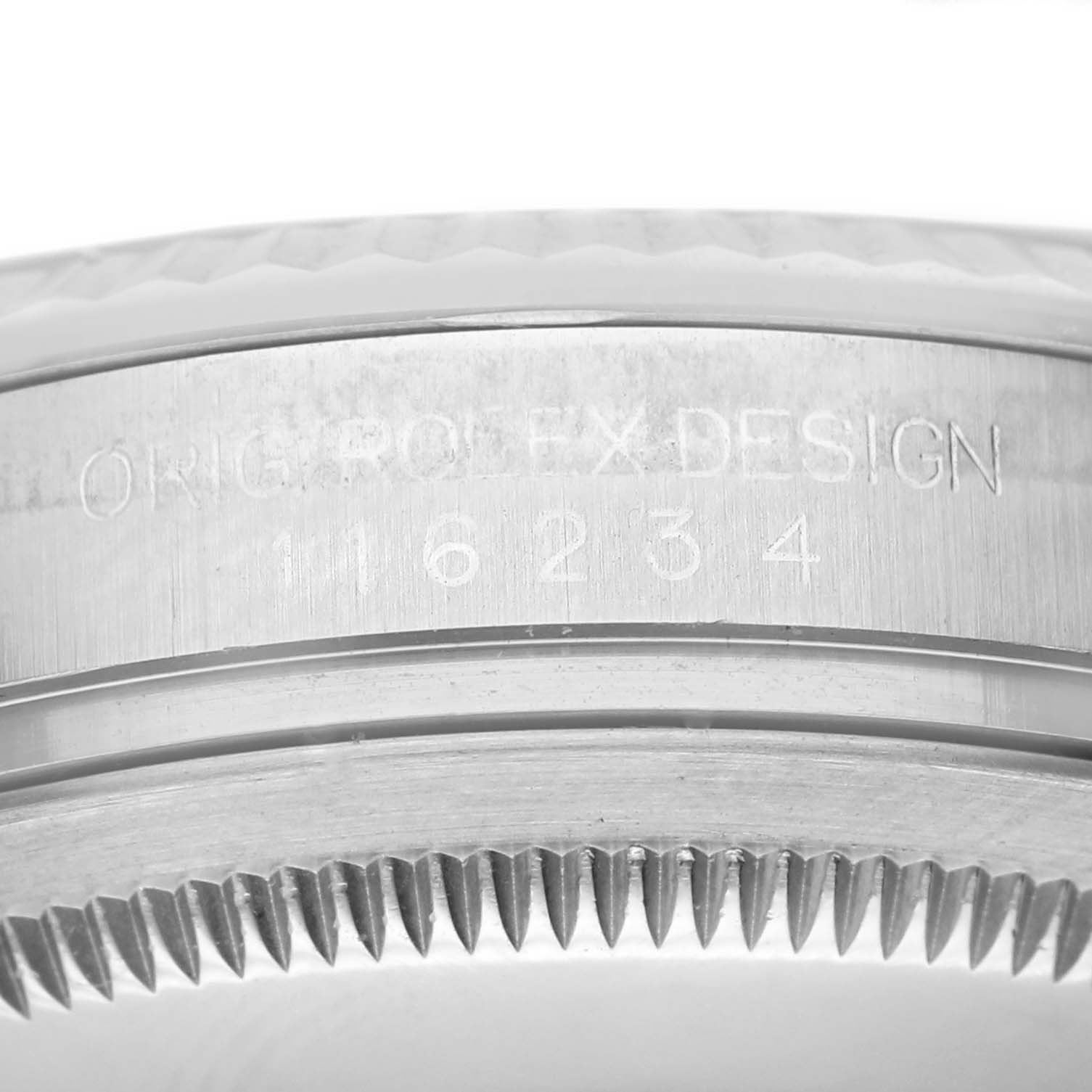 This close-up image shows the engraved case side of a Rolex Datejust 116234 Men's Stainless Steel Blue Dial 116234 Men's Stainless Steel Blue Dial watch, displaying the model number and bezel teeth.