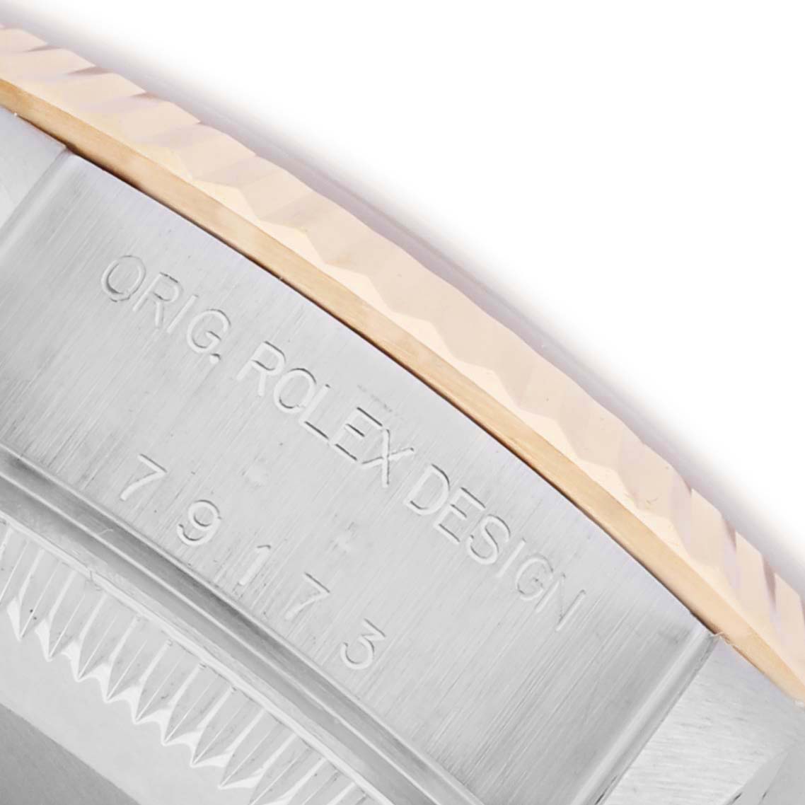 The image shows a close-up of the Rolex Datejust 79173 Women's Steel and Gold (two tone) Black Dial 79173 Women's Steel and Gold (two tone) Black Dial case's side, focusing on the bezel and engraved serial number.