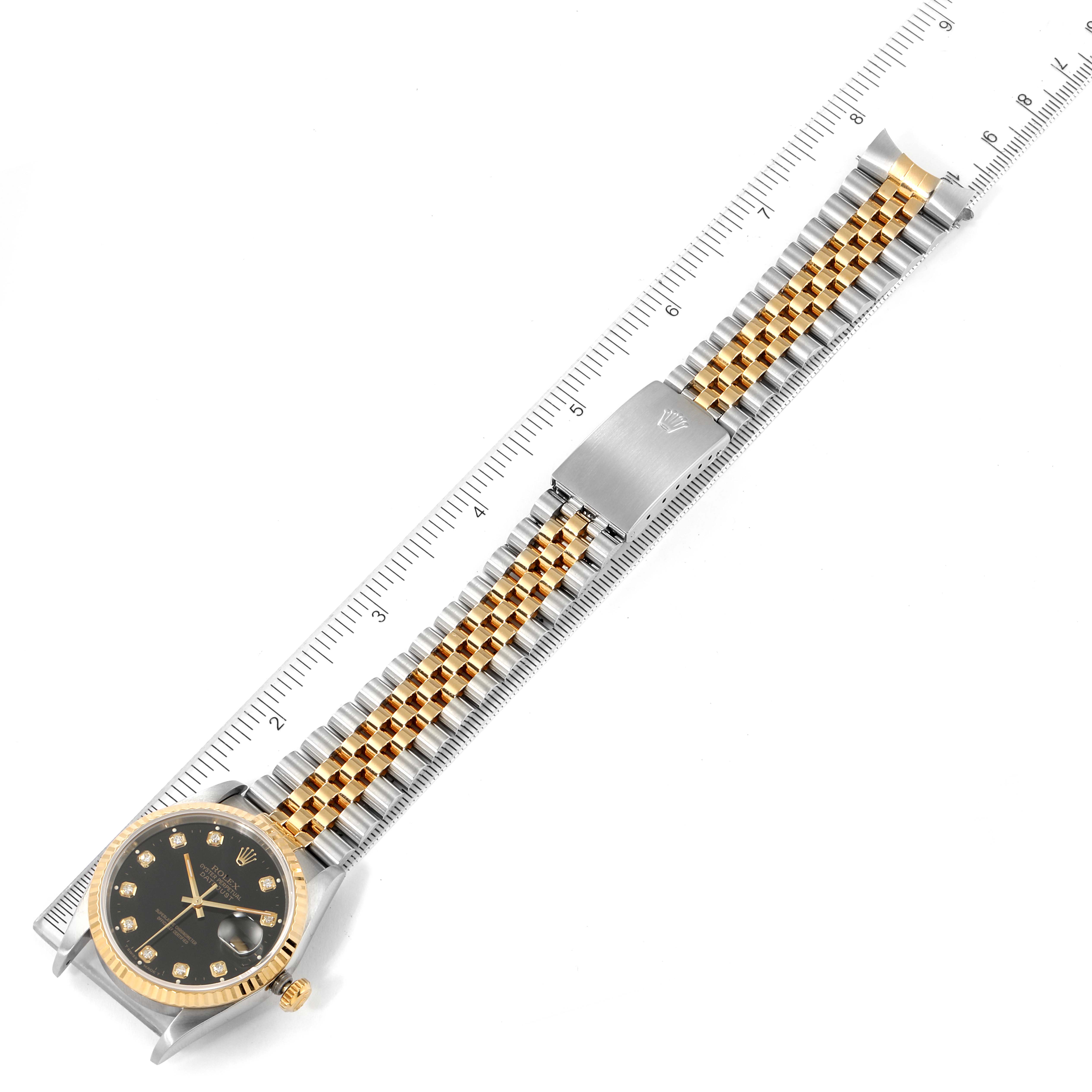 The image shows an overhead view of a Rolex Datejust 16233 Men's Steel and Gold (two tone) Black Dial 16233 Men's Steel and Gold (two tone) Black Dial watch, highlighting its face, bezel, bracelet, and clasp.