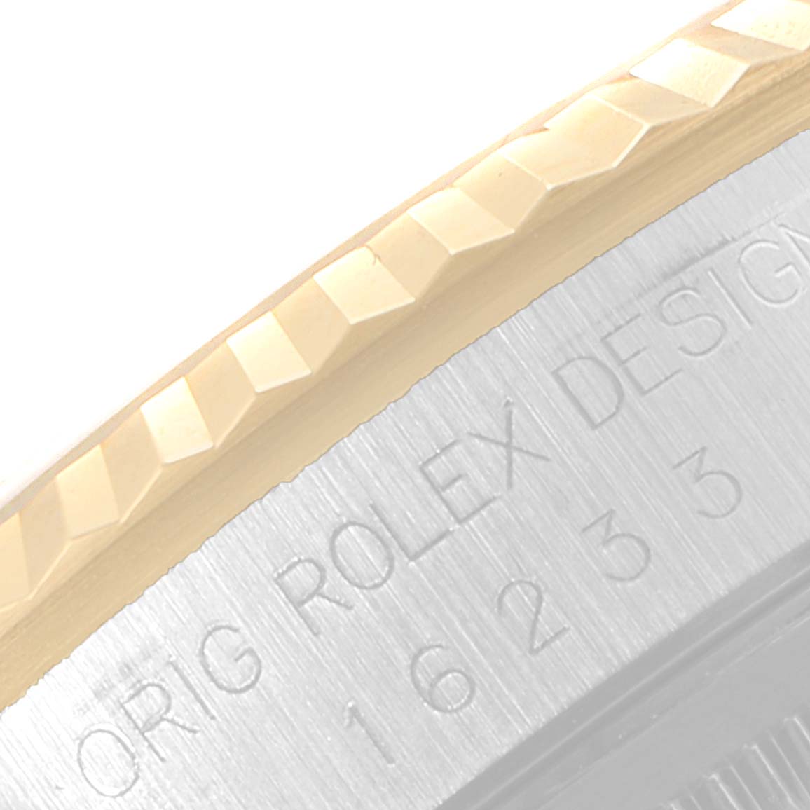 This image shows a close-up of the side of the bezel and case of a Rolex Datejust 16233 Men's Steel and Gold (two tone) Black Dial 16233 Men's Steel and Gold (two tone) Black Dial watch, featuring the engraved Rolex design.