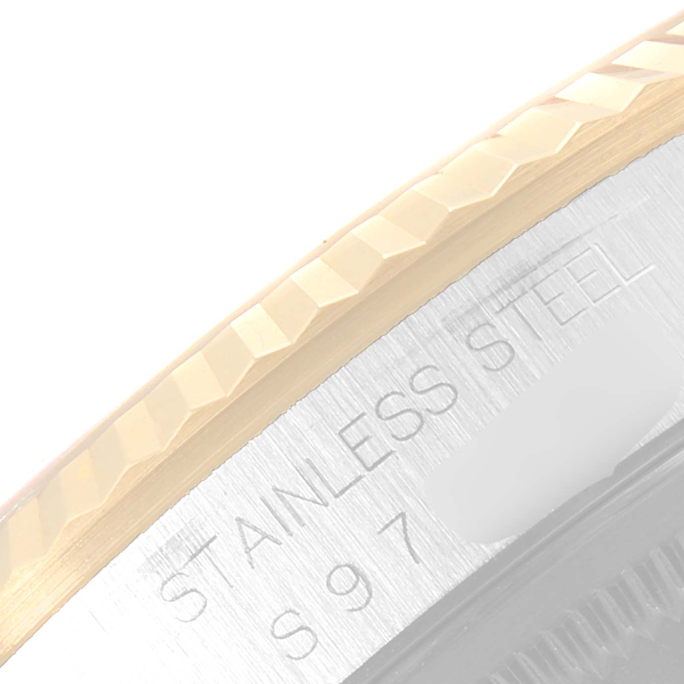 This image shows a close-up of the fluted bezel and part of the stainless steel case of the Rolex Datejust 16233 Men's Steel and Gold (two tone) Black Dial 16233 Men's Steel and Gold (two tone) Black Dial model.