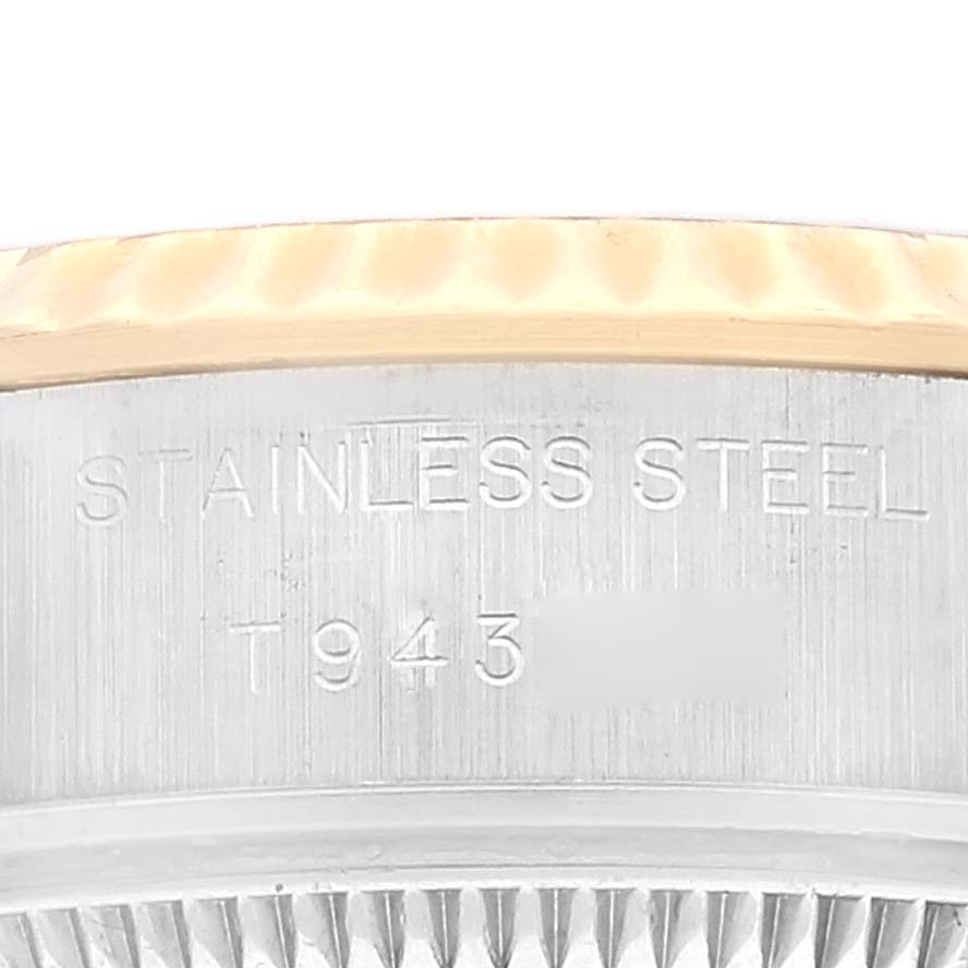 This image shows a close-up of the side engraving and part of the bezel of a Rolex Datejust 69173 Women's Steel and Gold (two tone) Champagne Dial 69173 Women's Steel and Gold (two tone) Champagne Dial watch.