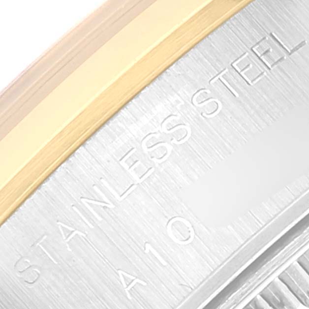 This close-up image shows part of the bezel and case back of a Rolex Datejust 79163 Women's Steel and Gold (two tone) Champagne Dial 79163 Women's Steel and Gold (two tone) Champagne Dial watch, highlighting the "STAINLESS STEEL" engraving.