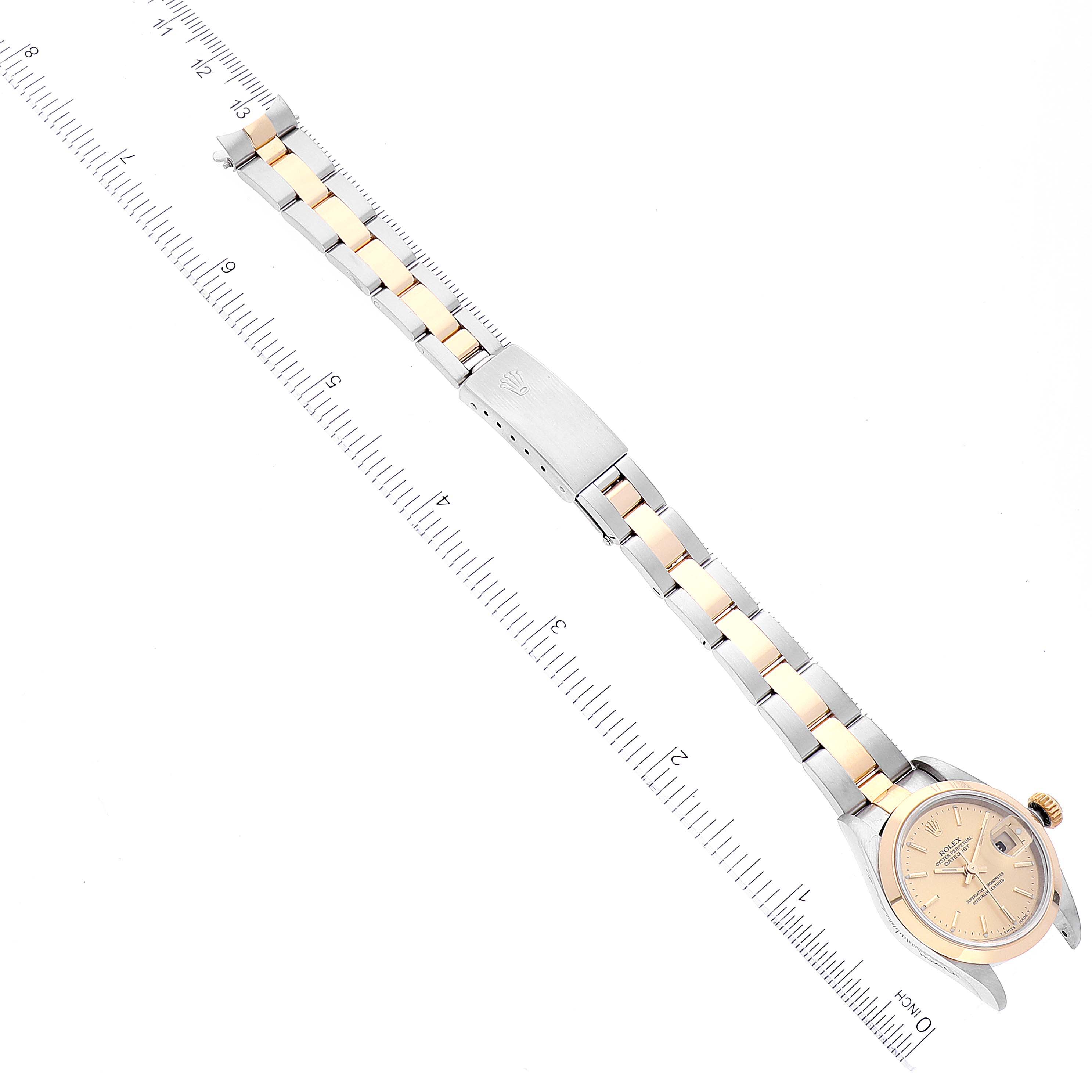 The image shows a Rolex Datejust 79163 Women's Steel and Gold (two tone) Champagne Dial 79163 Women's Steel and Gold (two tone) Champagne Dial watch laid flat, showcasing the dial, bracelet, and clasp, with a ruler alongside for scale.